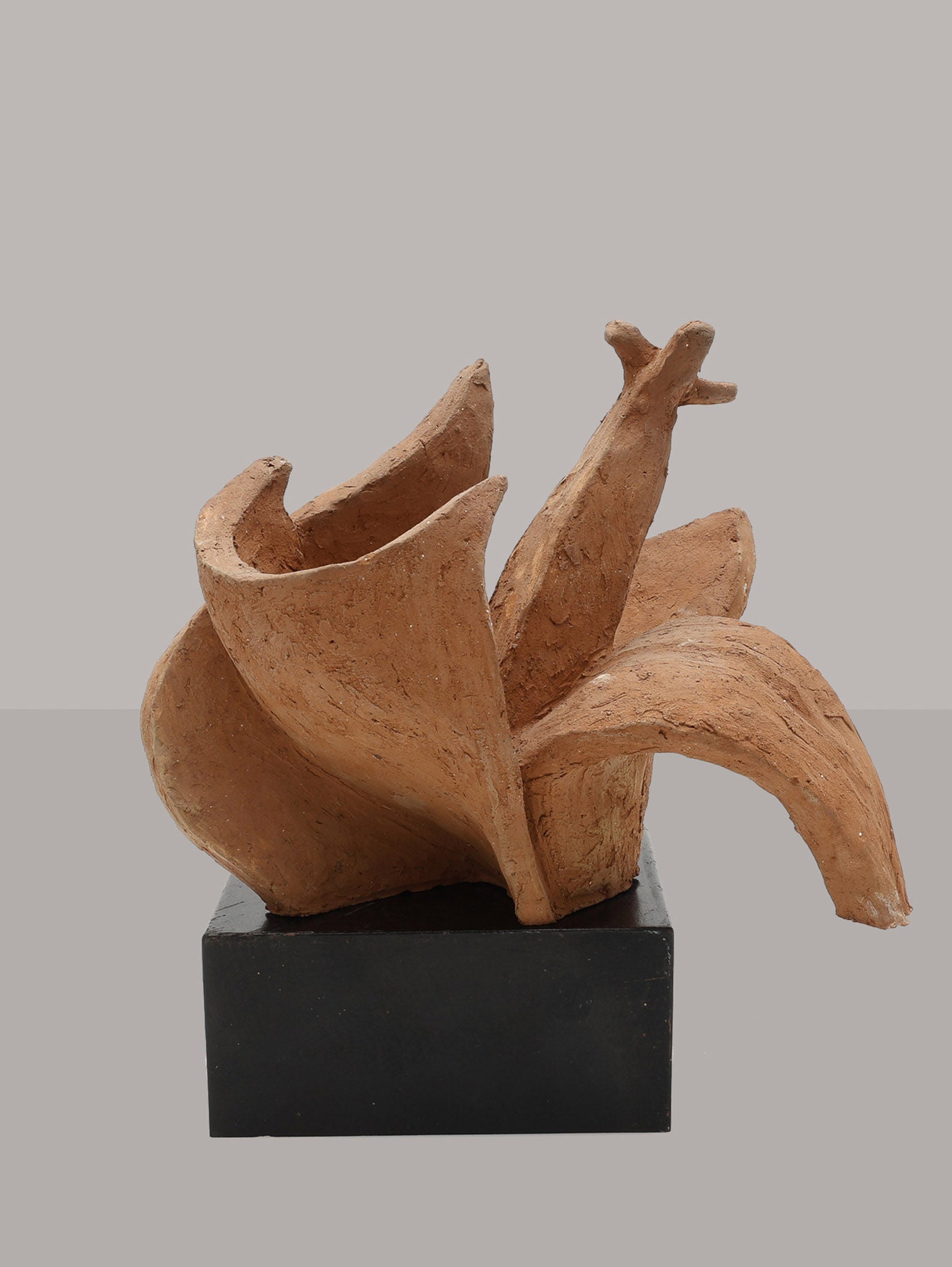 The Organic Sculpture by Kristian Holmqvist (1928β2015) from RELIC LONDON features an abstract terracotta form resembling a stylized bird with outstretched wings, mounted on a black rectangular base against a neutral background.