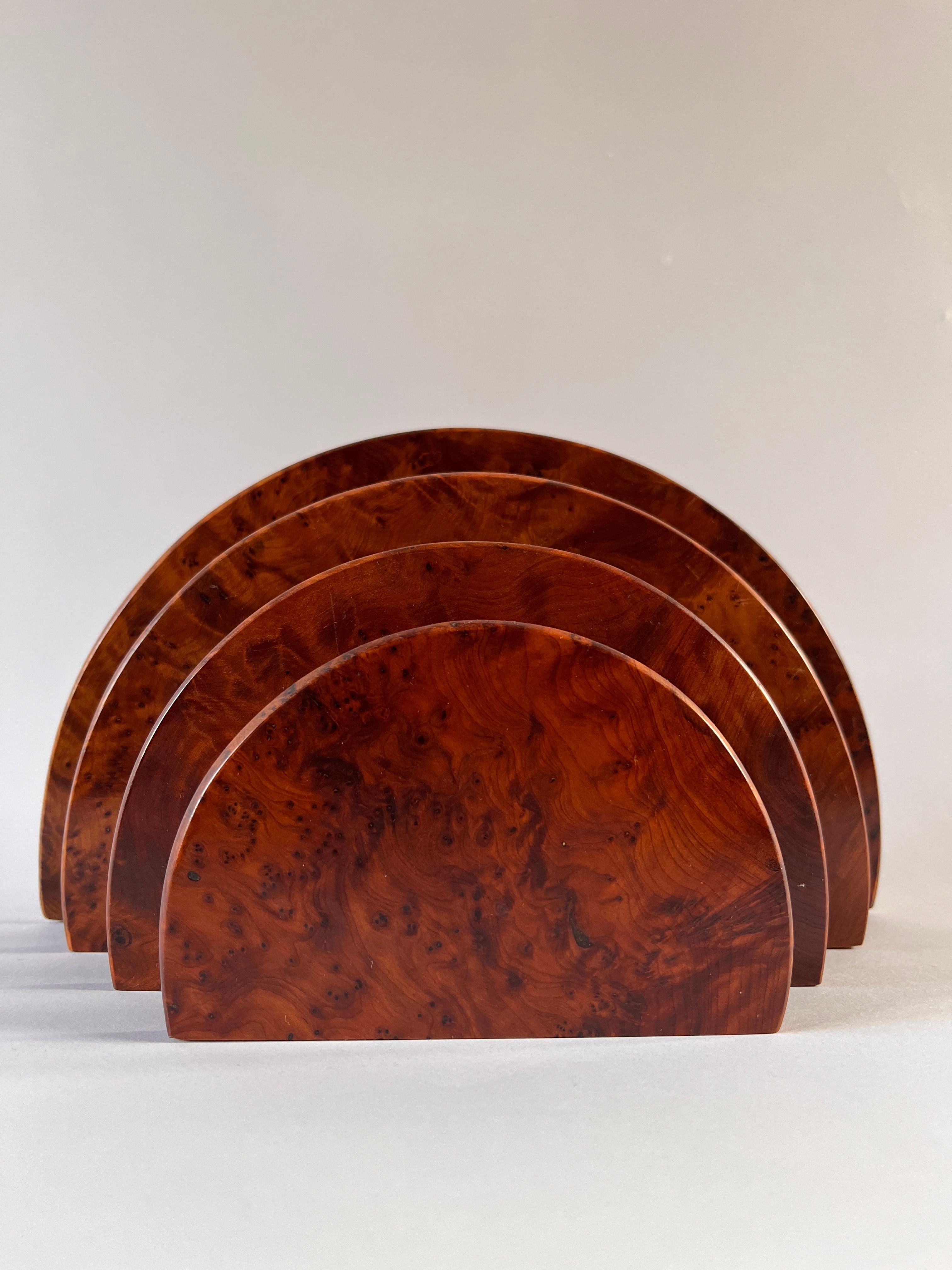 The Art Deco Burr Walnut Letter Holder by Maud Vaughan is a set of four semi-circular wooden pieces, resembling a desk organizer, arranged in a row with each slightly overlapping the next against a plain background. The wood exhibits a rich, reddish-brown color and showcases an exquisite burr veneer with its natural grain pattern beautifully visible.
