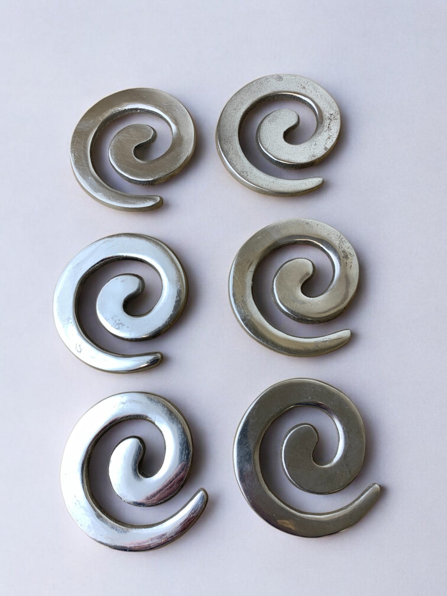 Set of six spiral aluminum coasters in biomorphic design, Spain 1980s