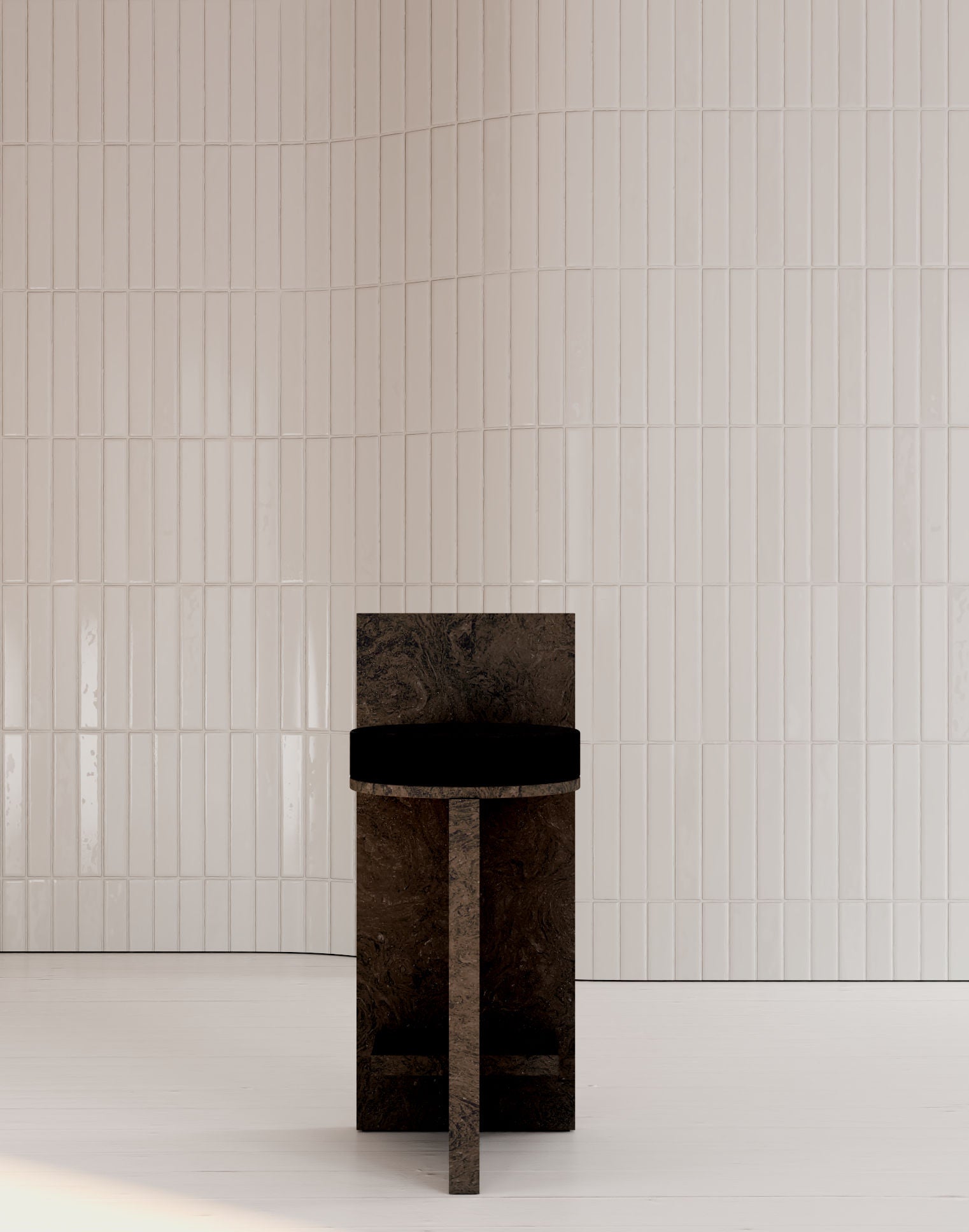 The Meï 02 Stool Bar by volta, a modern minimalist dark stone chair, stands on a white floor against glossy vertical white tiles, highlighting clean lines, textured surfaces, and the unique appeal of a made-to-order design.
