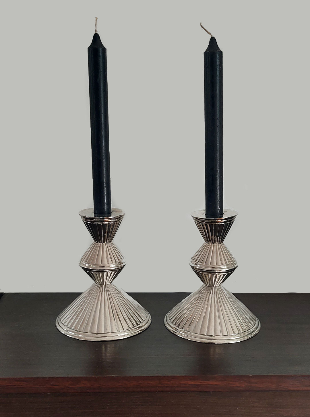 Handcrafted metal candle holders featuring intricate floral designs in a set of 2