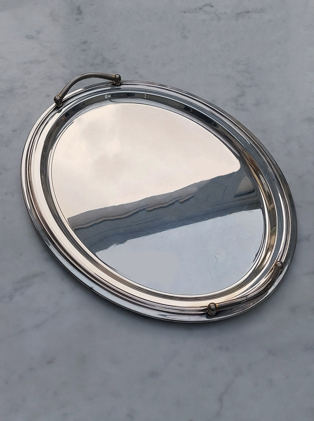 Large silver-plated oval tray with intricate filigree design and ornate handles