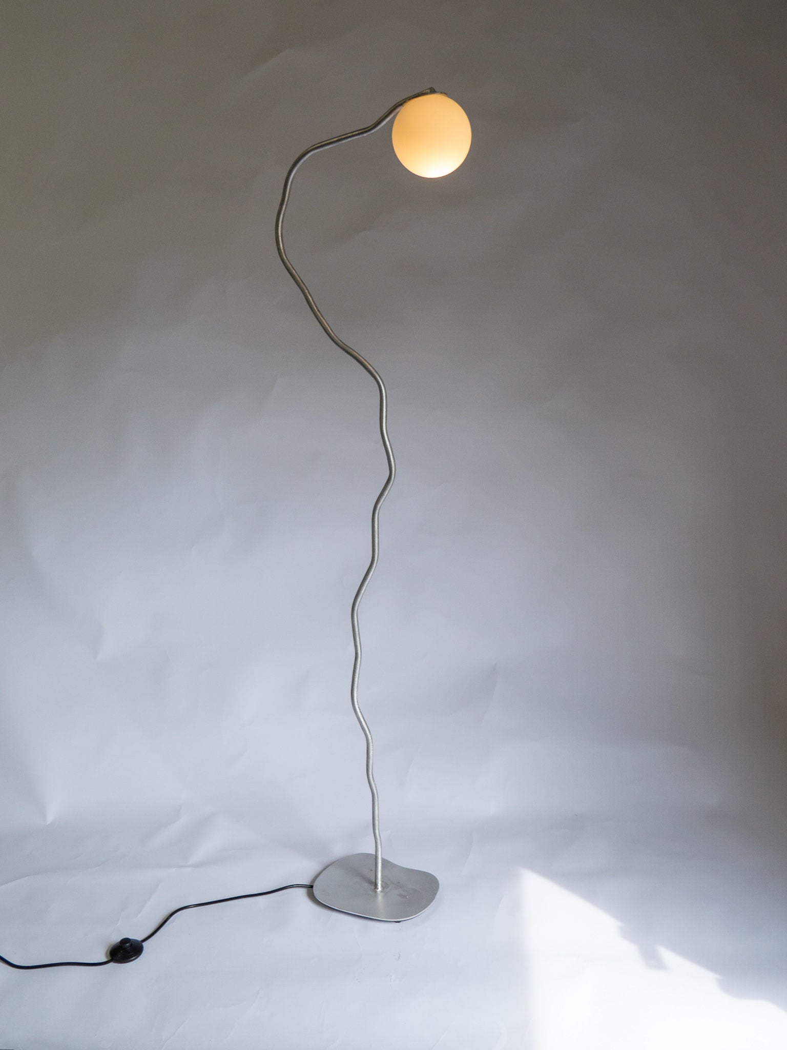 Modern black floor lamp with adjustable head and sleek design