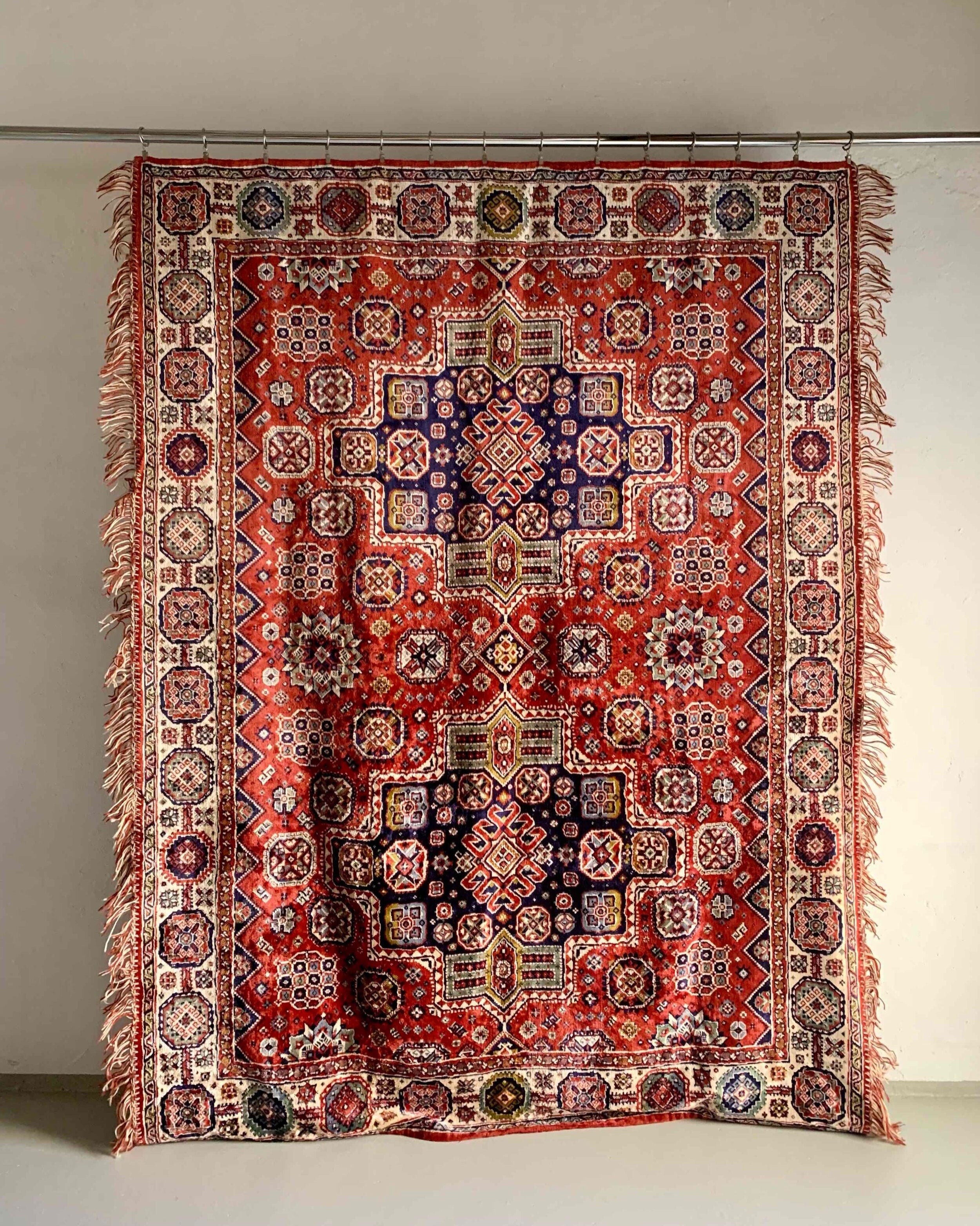 The Veter Vintage "Vintage Silk Oriental Duvet Cover - Rug" features bold geometric and floral patterns in red, white, purple, and black, with slightly uneven fringed edges that add charm to this eye-catching decorative piece.