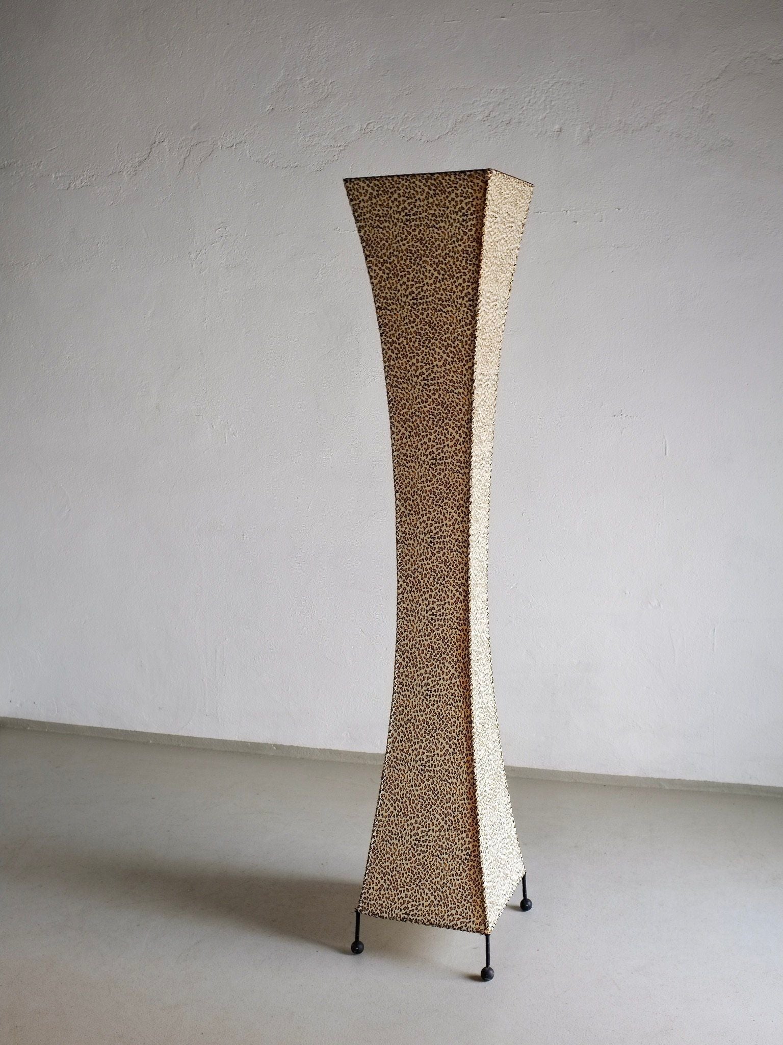 The Leopard Print Floor Lamp by Veter Vintage (1980s) features a tall, curved design with leopard print pattern and four small legs, shown against a plain white wall and light gray floor.