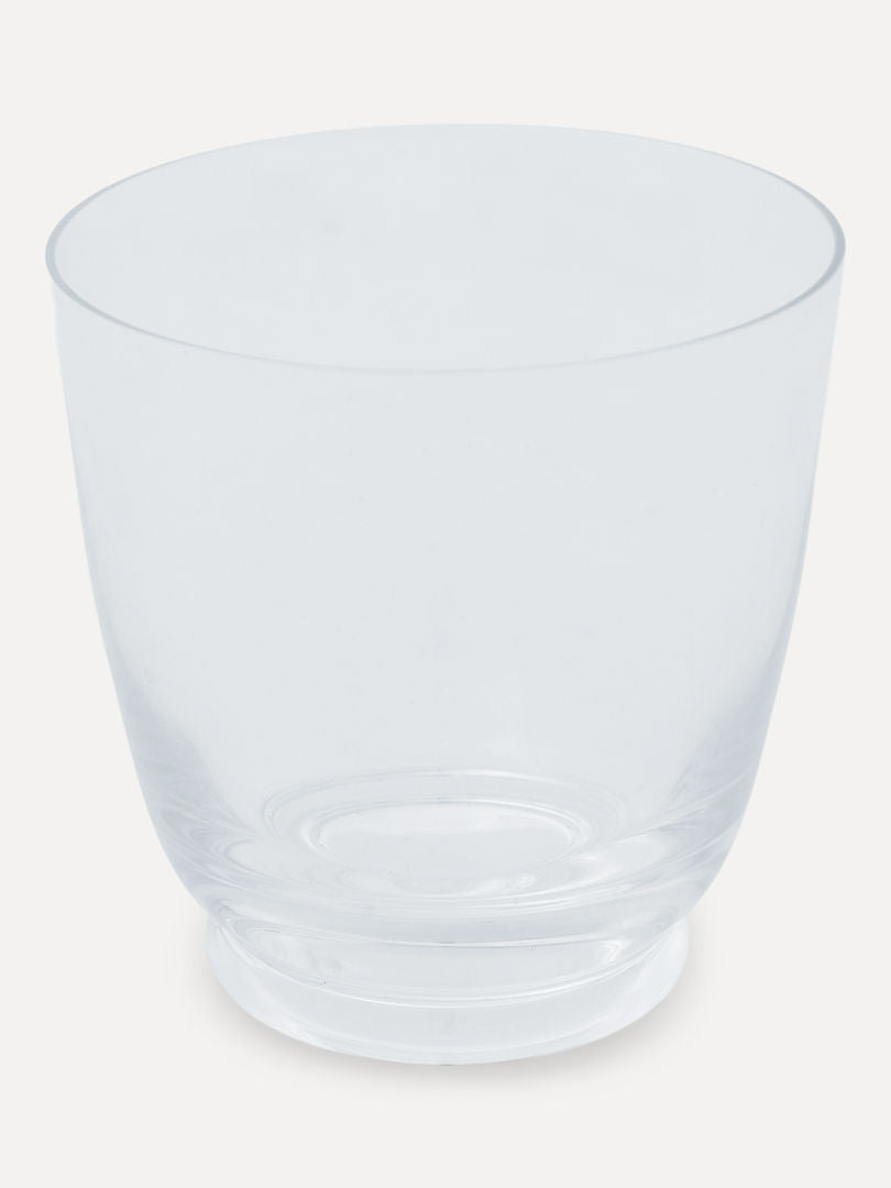 A clear, empty Walter 01 - Tumbler by Service Projects, with a wide rim and a slightly narrower base, stands against a plain, light background, showcasing the elegance of mouth-blown glassware in an Art Deco style.