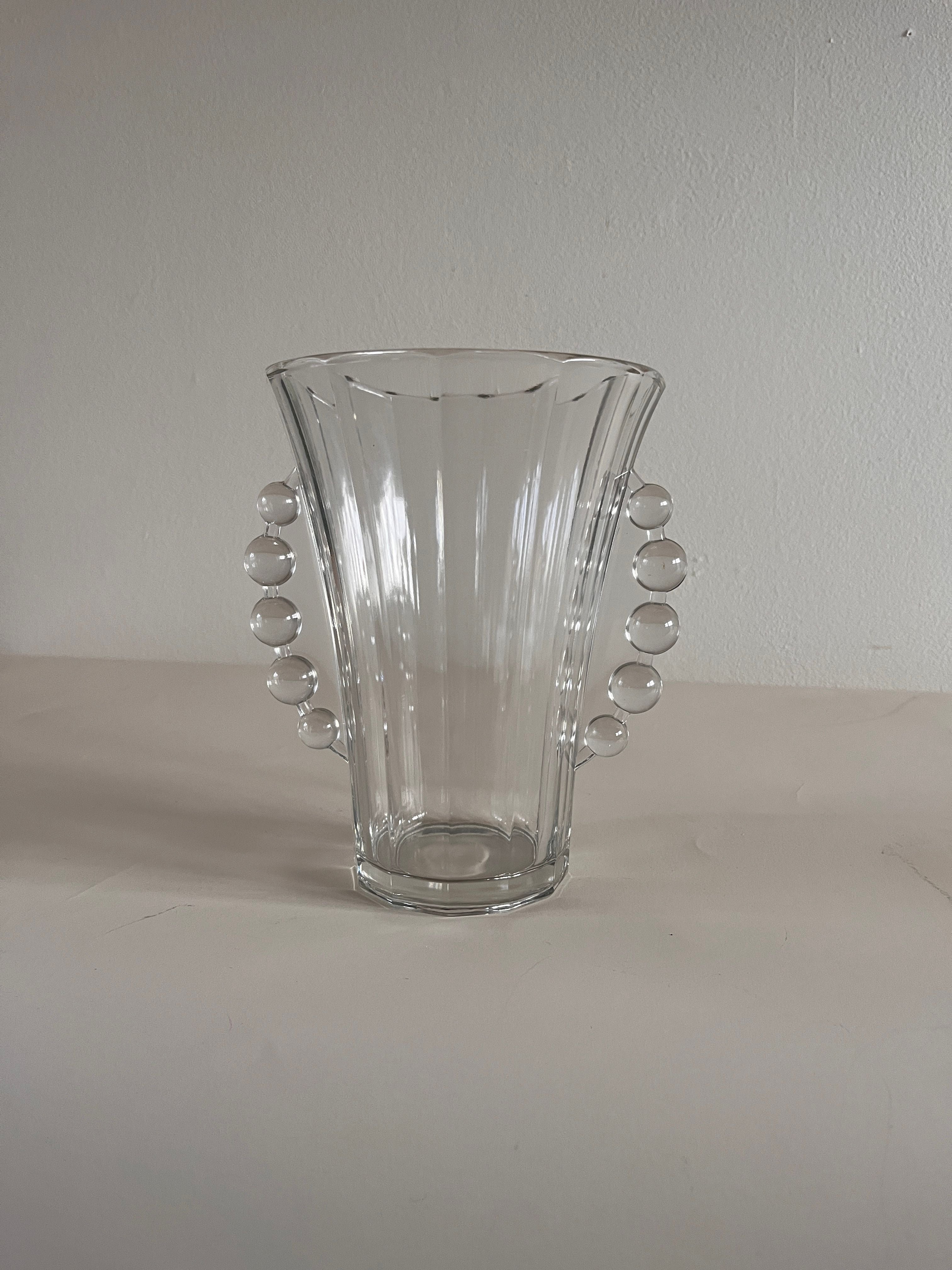 The Maud Vaughan Val Saint-Lambert Vase features a clear flared glass design with beaded handles crafted from spherical glass beads on each side, reminiscent of vintage designs, set against a plain light background.
