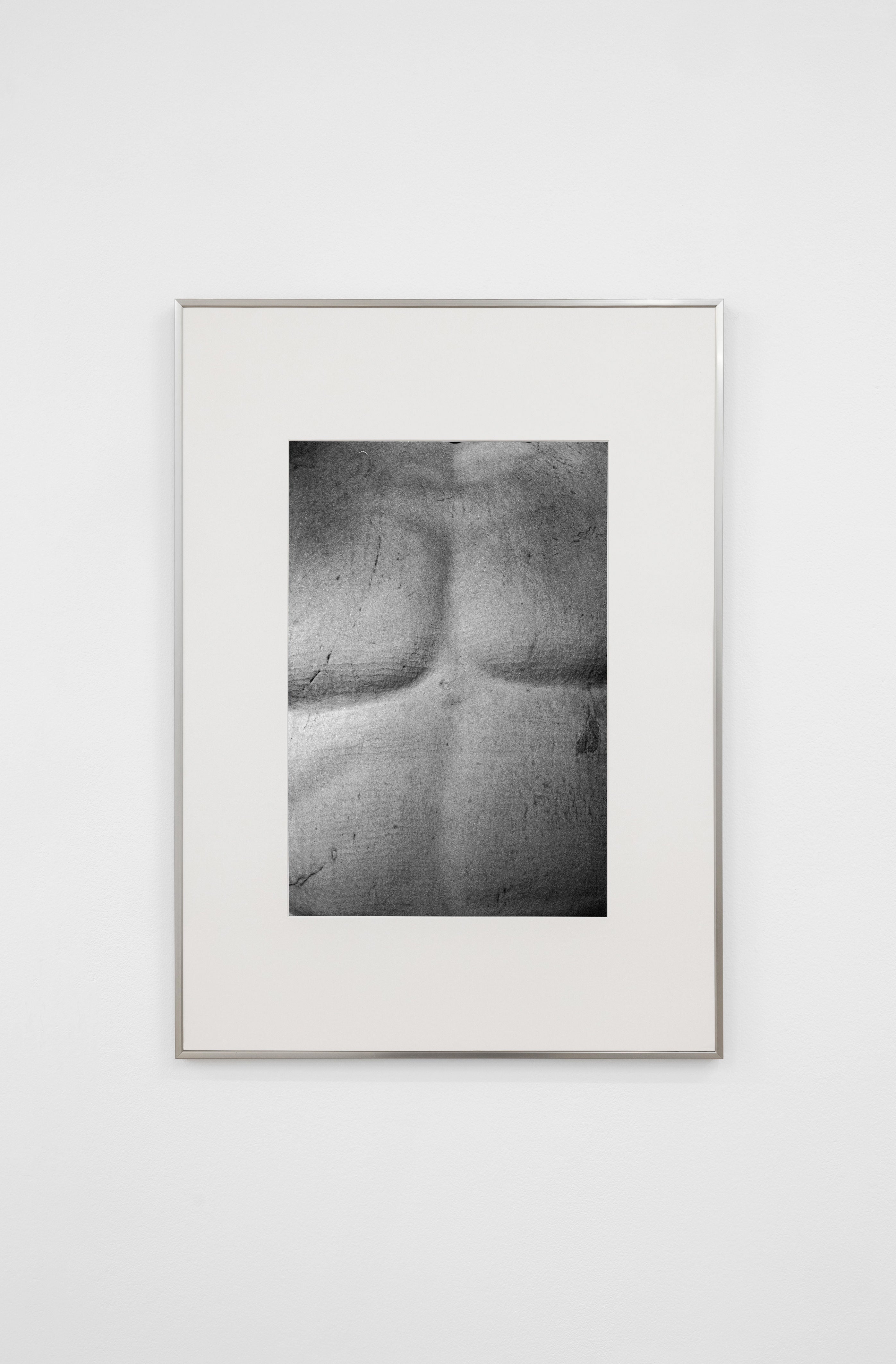 Black-and-white photo of Memory #15 - Pompei by COSEINCORSO, a framed limited edition print with textured horizontal and vertical indentations, in an abstract minimalist style, mounted on a white wall.