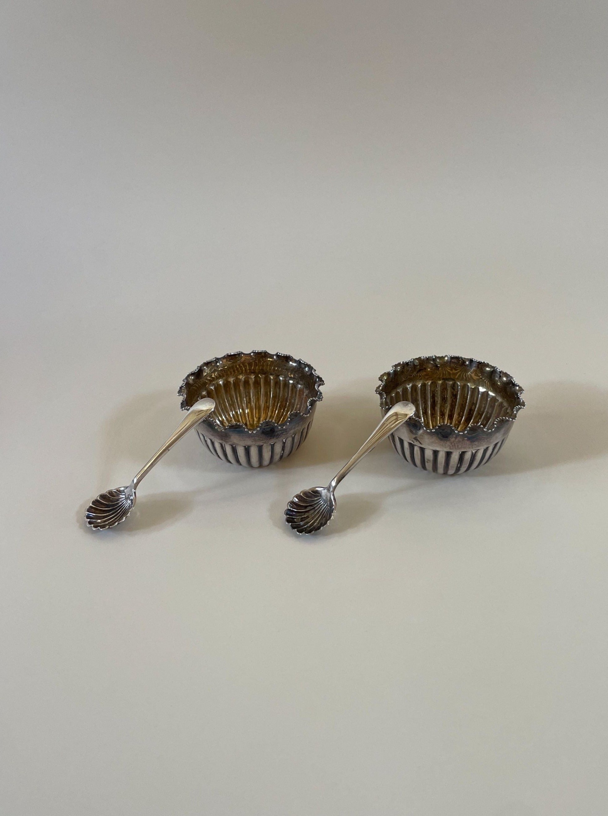 A pair of vintage Mappin and Webb silver salts with intricate detailing and elegant design
