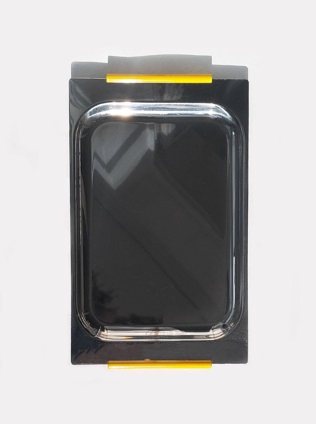 A square black Les Objoies steel rectangular minimalist tray with a metallic finish, outlined by a gray casing featuring yellow stripes at the top and bottom, perfect for organizing desk essentials.