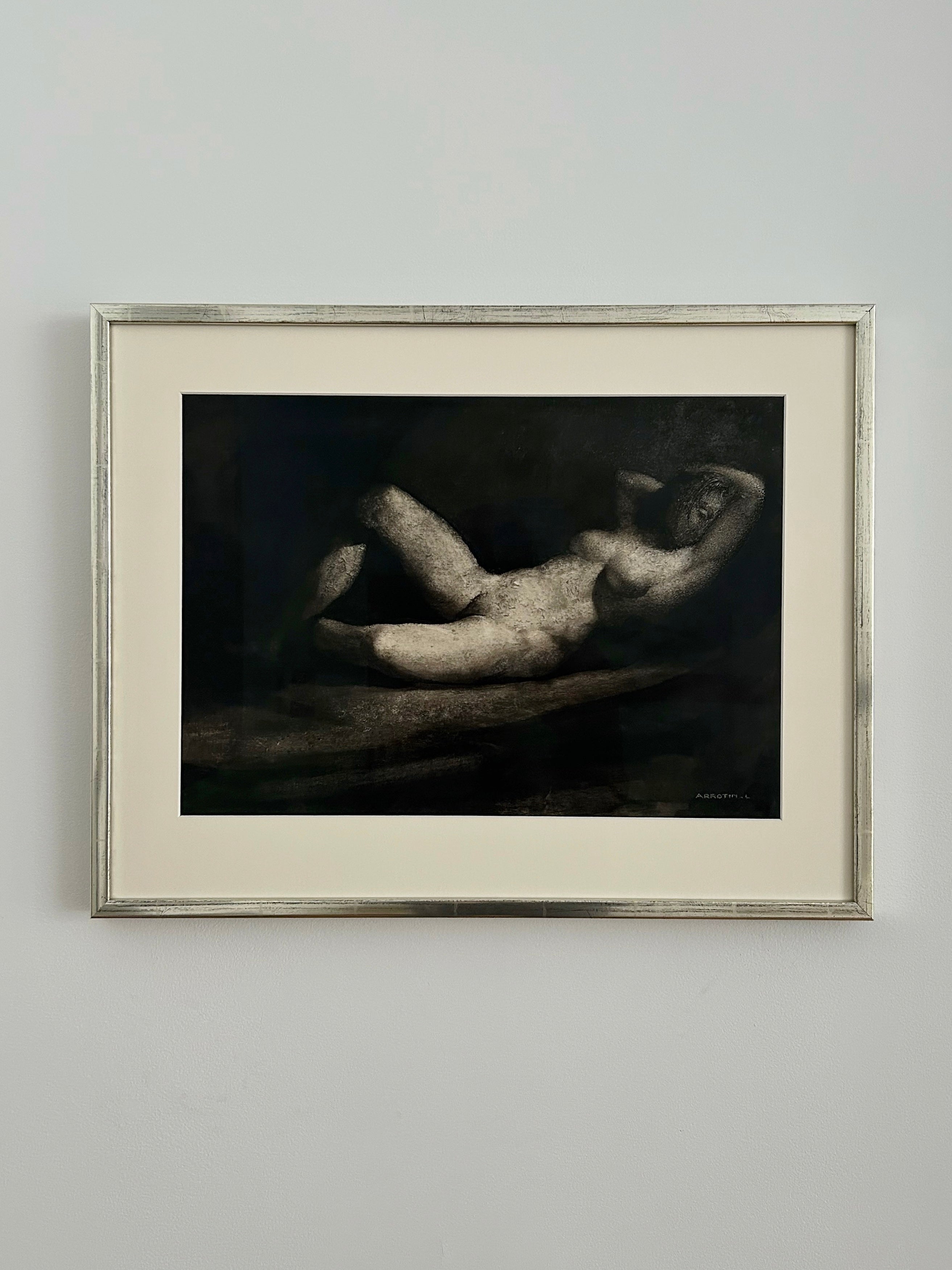 Reclining Nude by Léon Arrotin (1912–1978) from Galerie Storm features a classical monochrome reclining figure, softly rendered with textured shadows, framed and presented on a light wall.