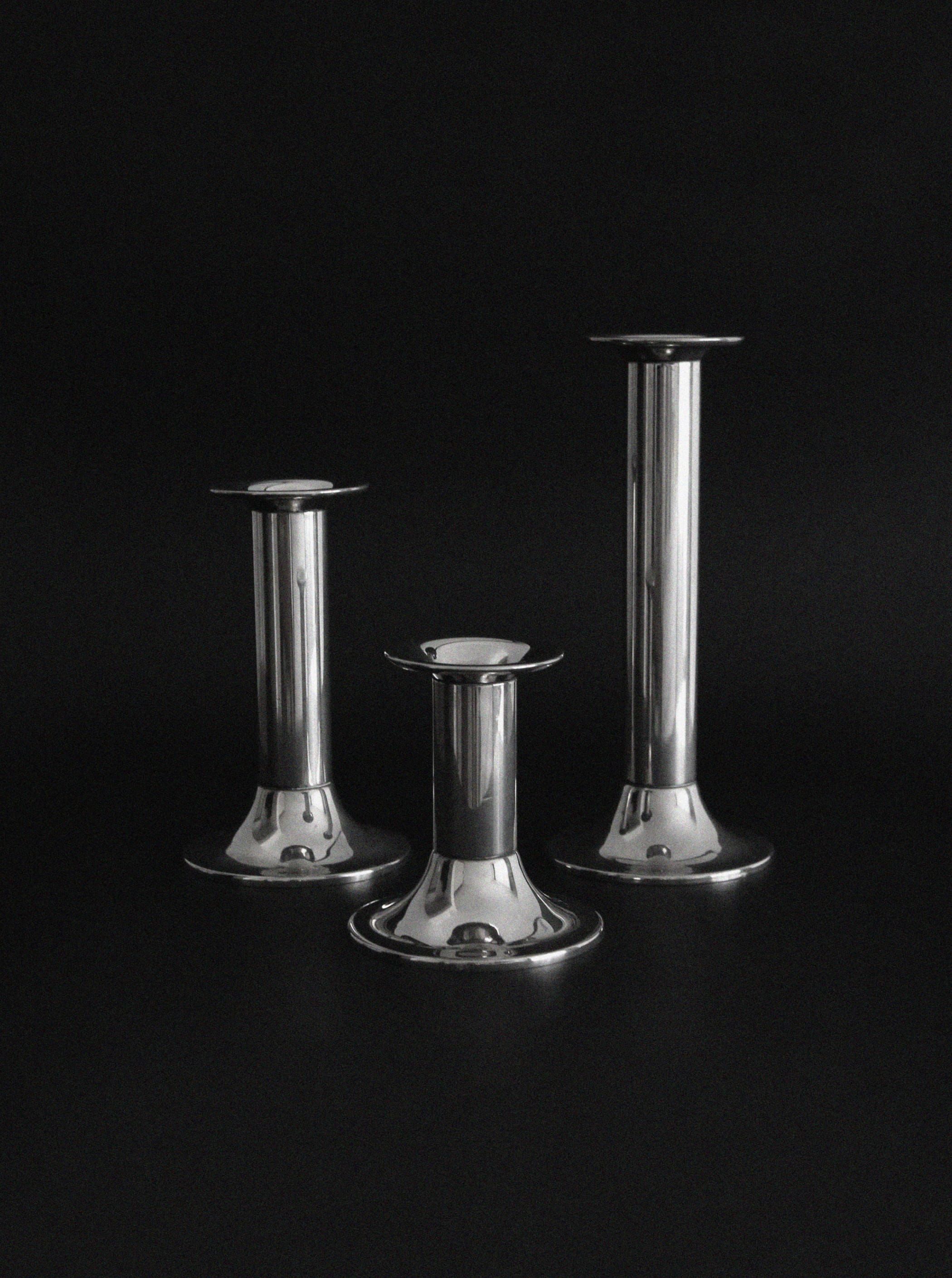 Three vintage silver plated candlesticks of varying heights