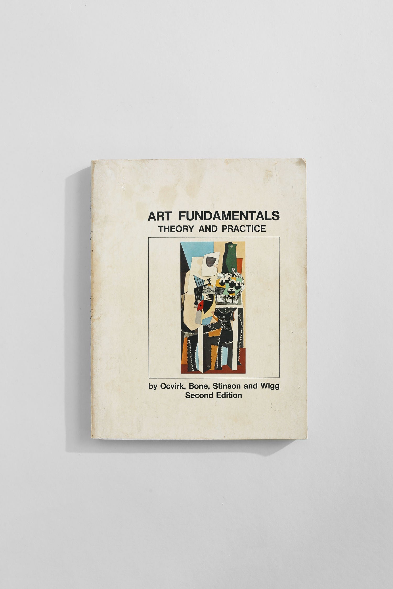 A worn paperback copy of Villa's 'Art Fundamentals' book—a vintage art guide featuring an abstract cover on a white background.