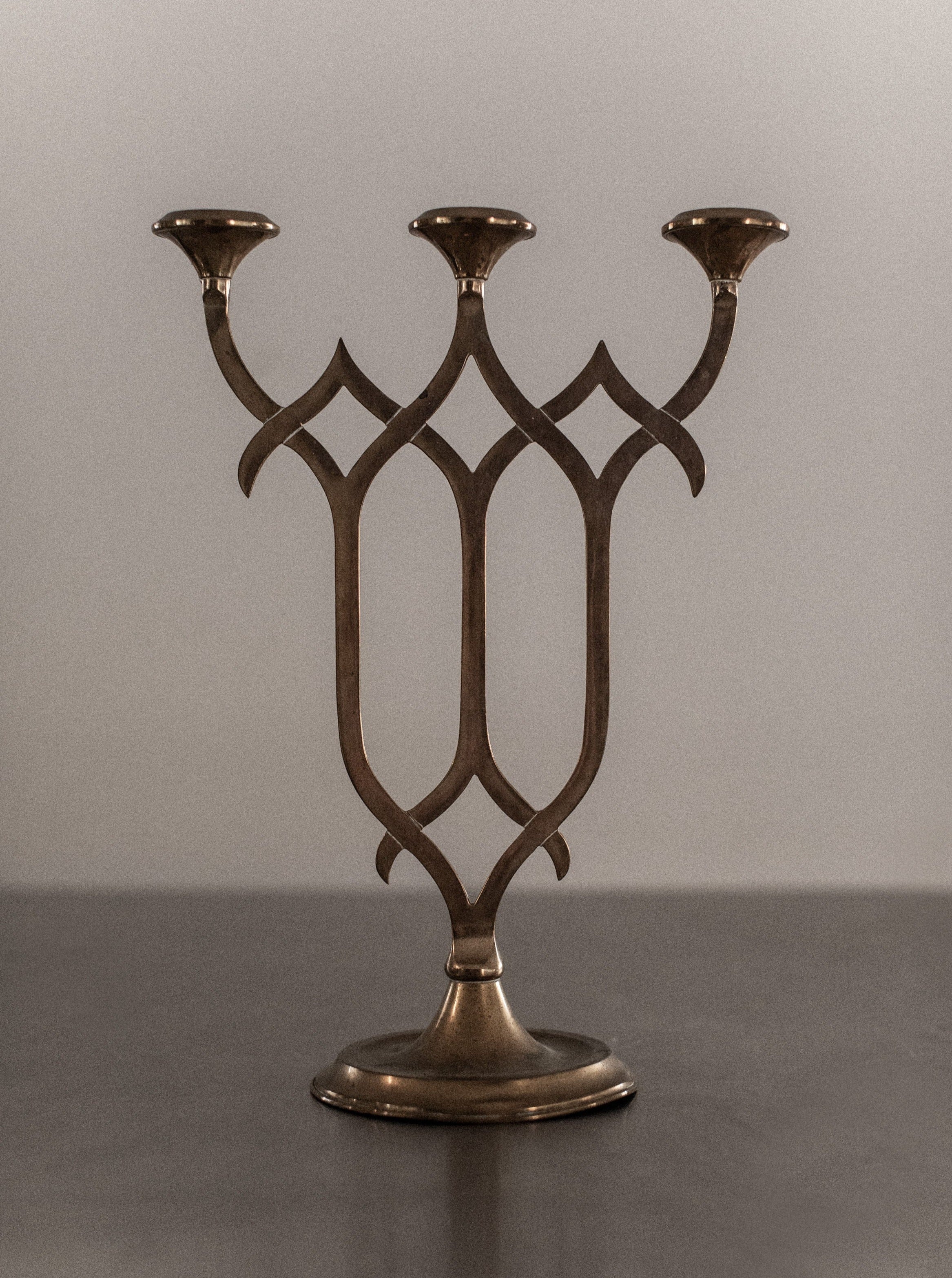 Elegant brass candleholder with tall, slender stem and round base