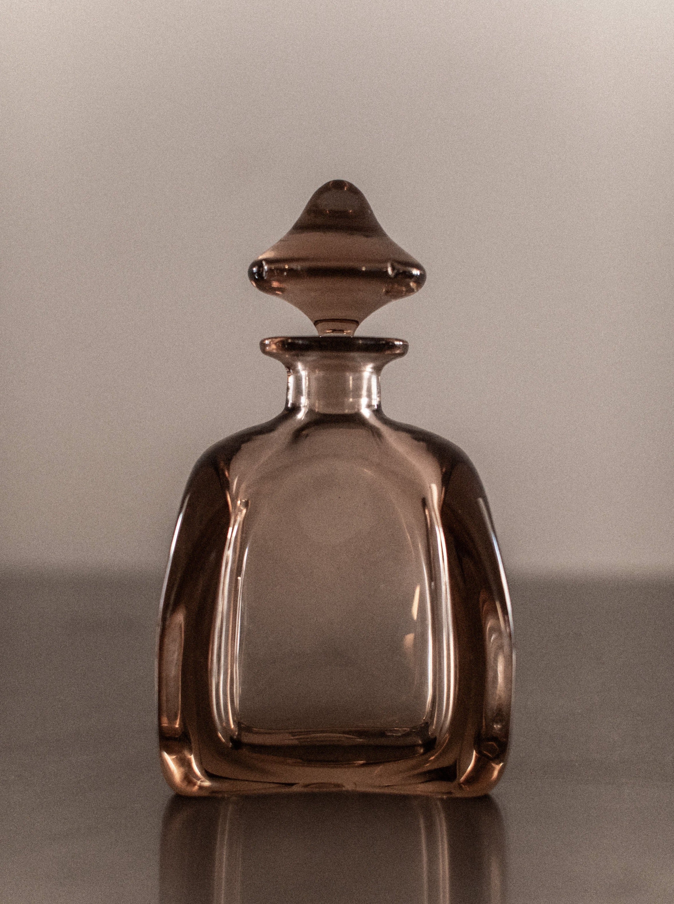 Antique crystal glass decanter with intricate diamond pattern and stopper