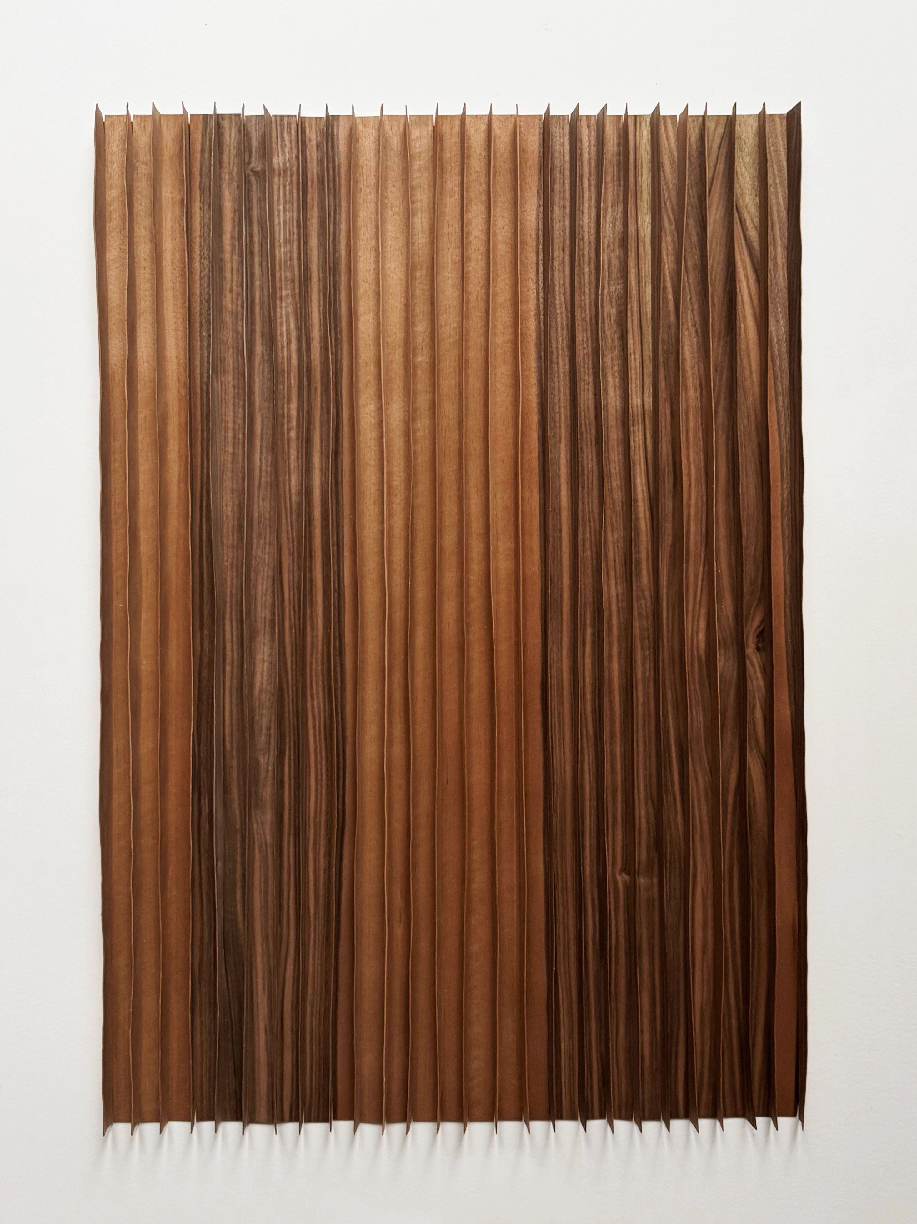 'Rhythm Wood' Artwork by Marike Andeweg features a rectangular, bark-like brown veneer mounted on a white wall, creating wave-like folds, dynamic shadows, and an eye-catching tactile texture.