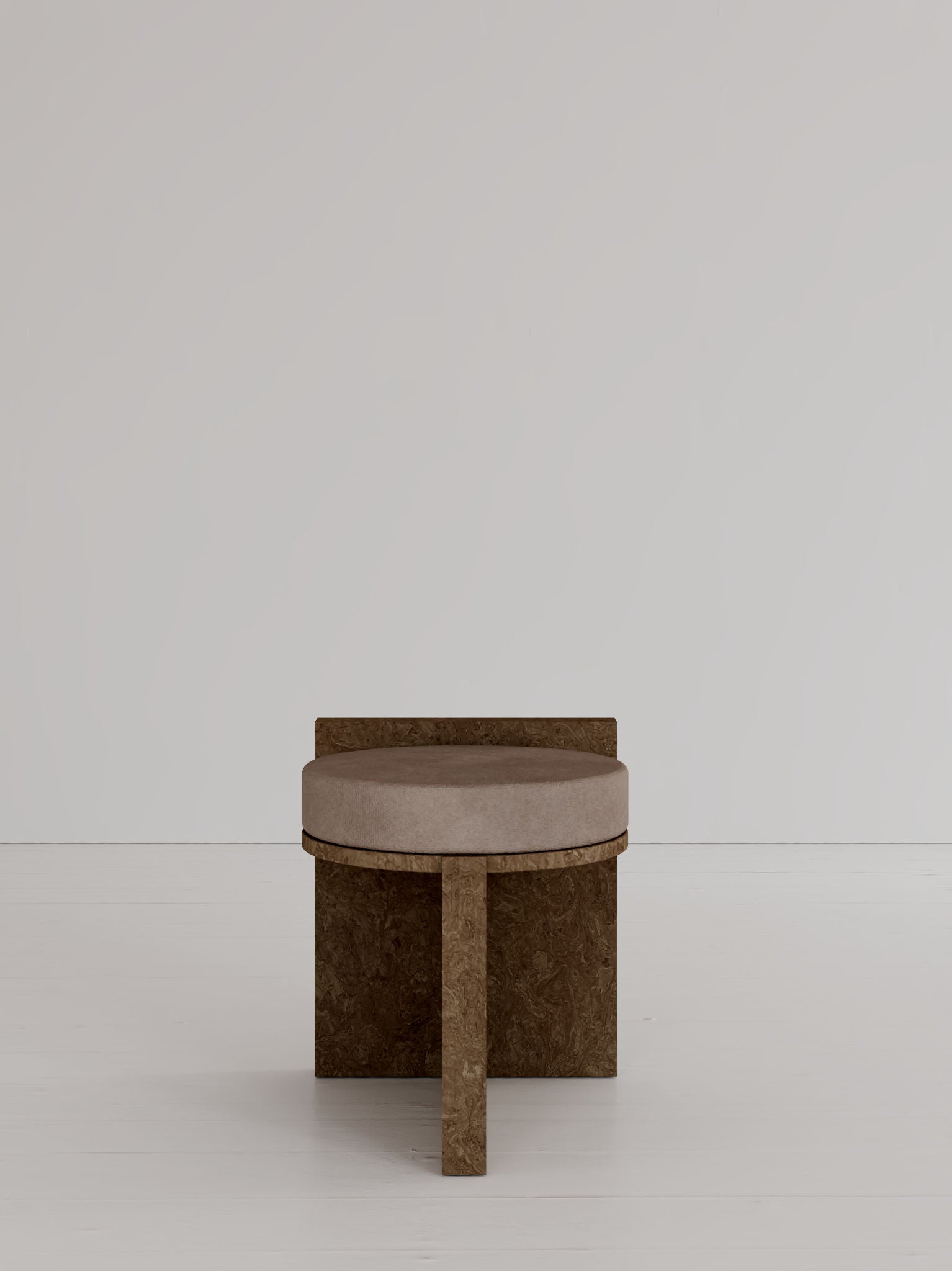 The 'Meï 01' Stool by volta features a minimalist design with a round beige velvet cushion and geometric brown wood base, shown against a light gray wall and white floor.
