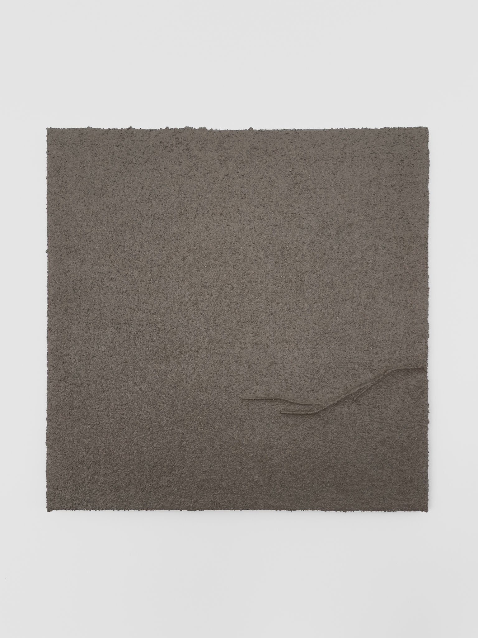 Shadow World 04 by Delal Salazar is a limited edition piece featuring acrylic and sand on canvas. The square dark brown artwork has rough edges and a raised, curving line from the lower right corner toward the center.