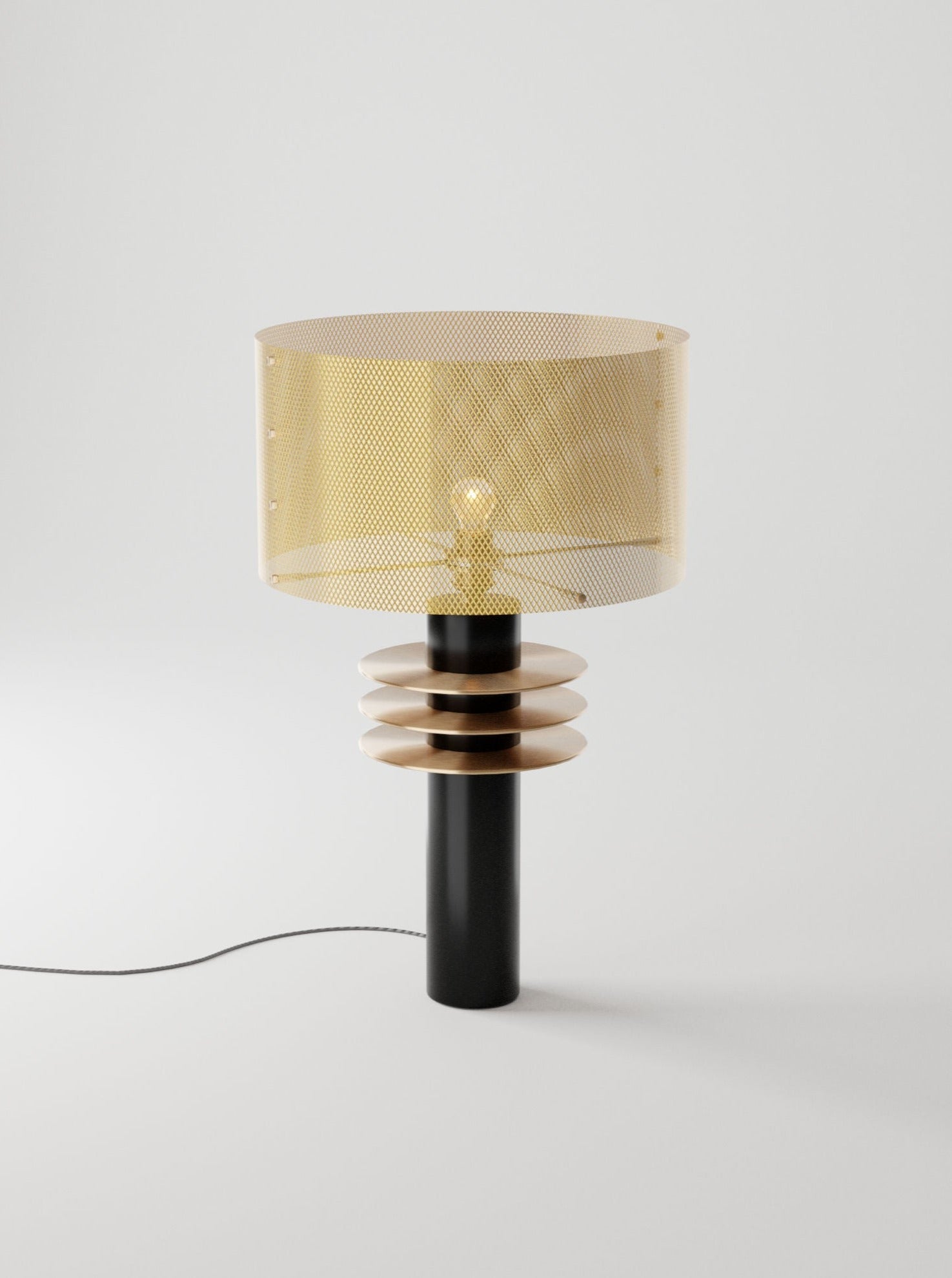 A modern Black Swan table lamp by Marine Breynaert featuring a unique design with a gold gilded lampshade, a bulb visible in the center, and a black and wooden spiral base on a light background.