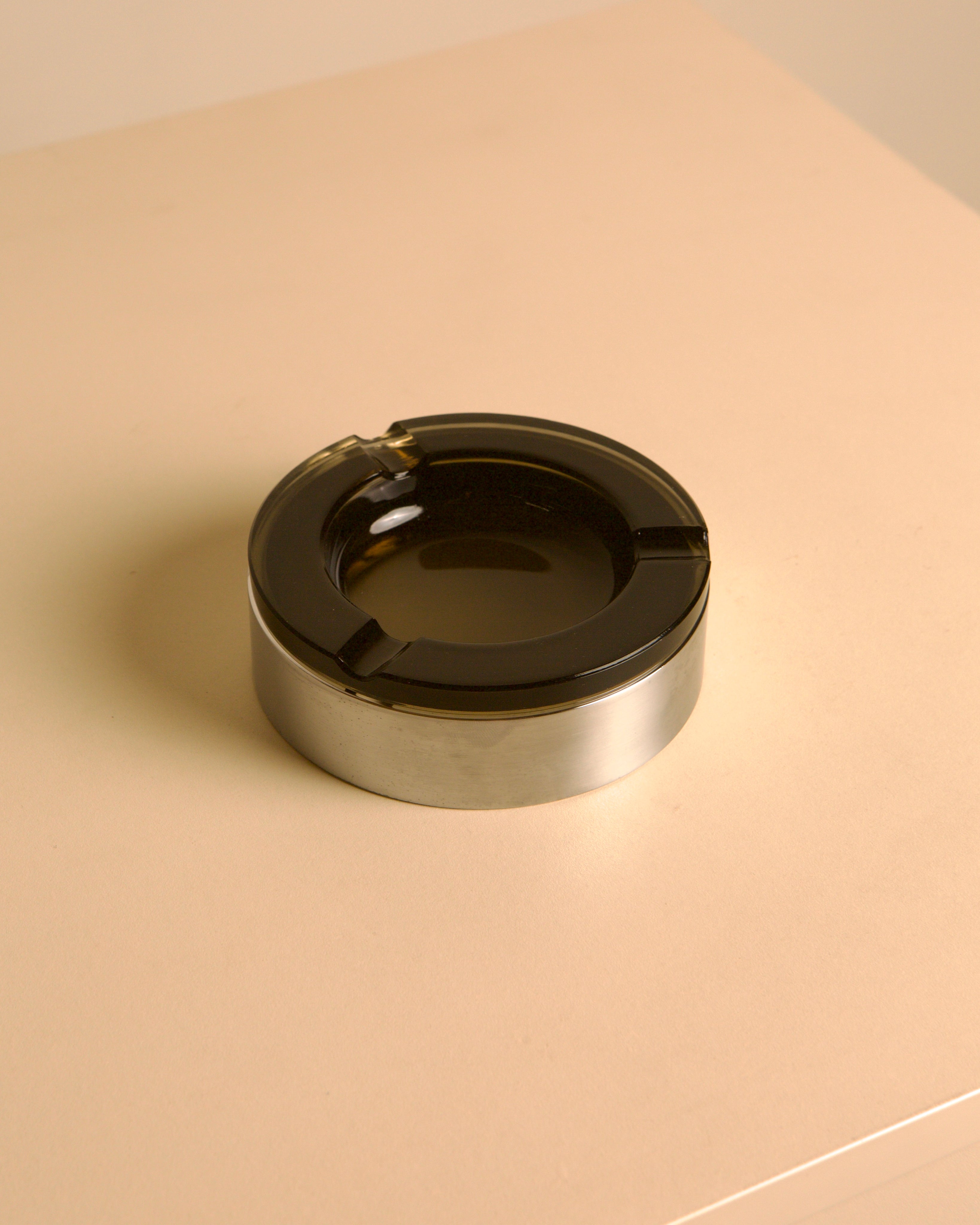 Italian circular metal and amber glass ashtray, 1970s by Treaptyque | The Oblist