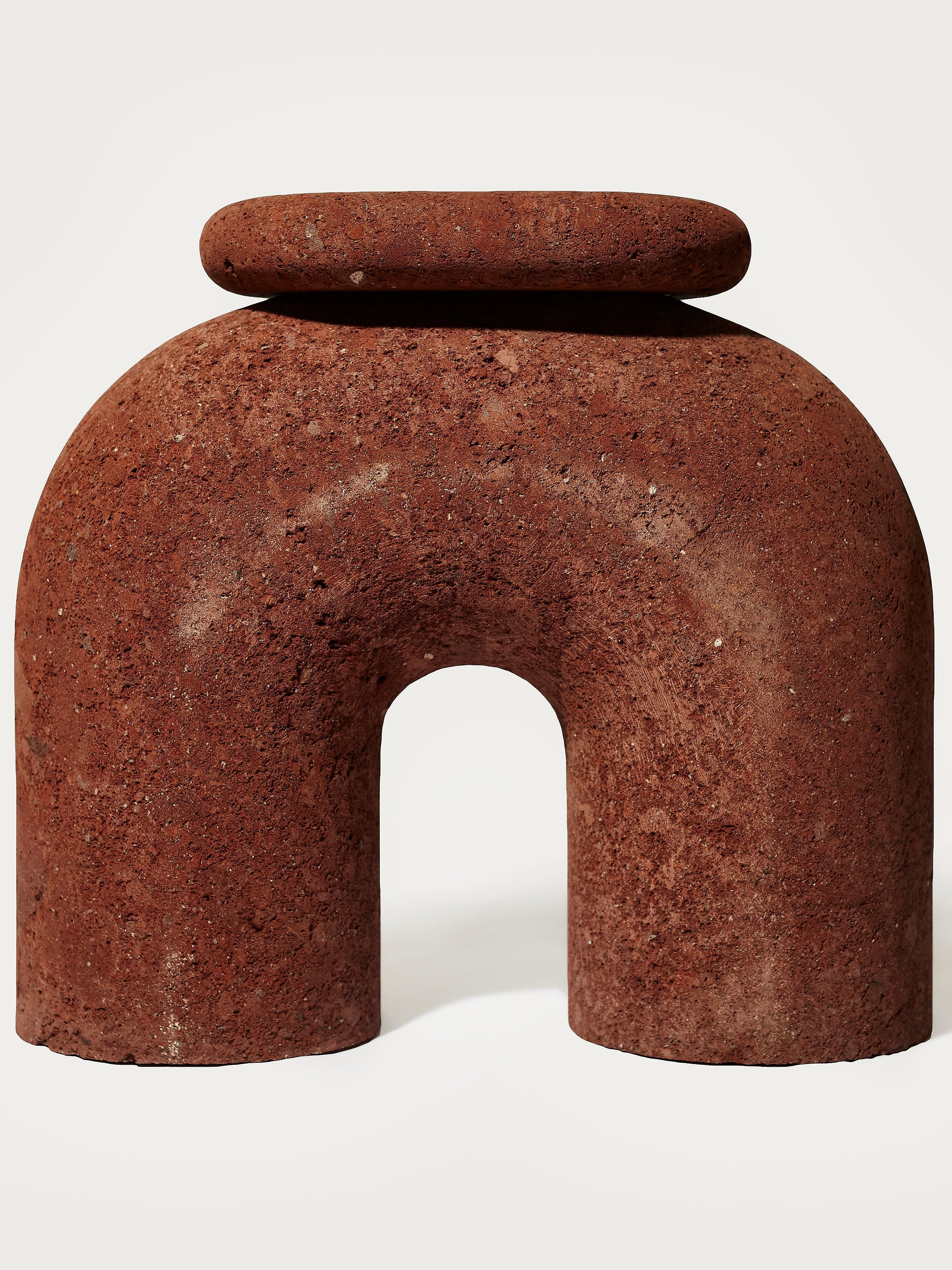 Neolithic' Stool — close-up of textured red stone material