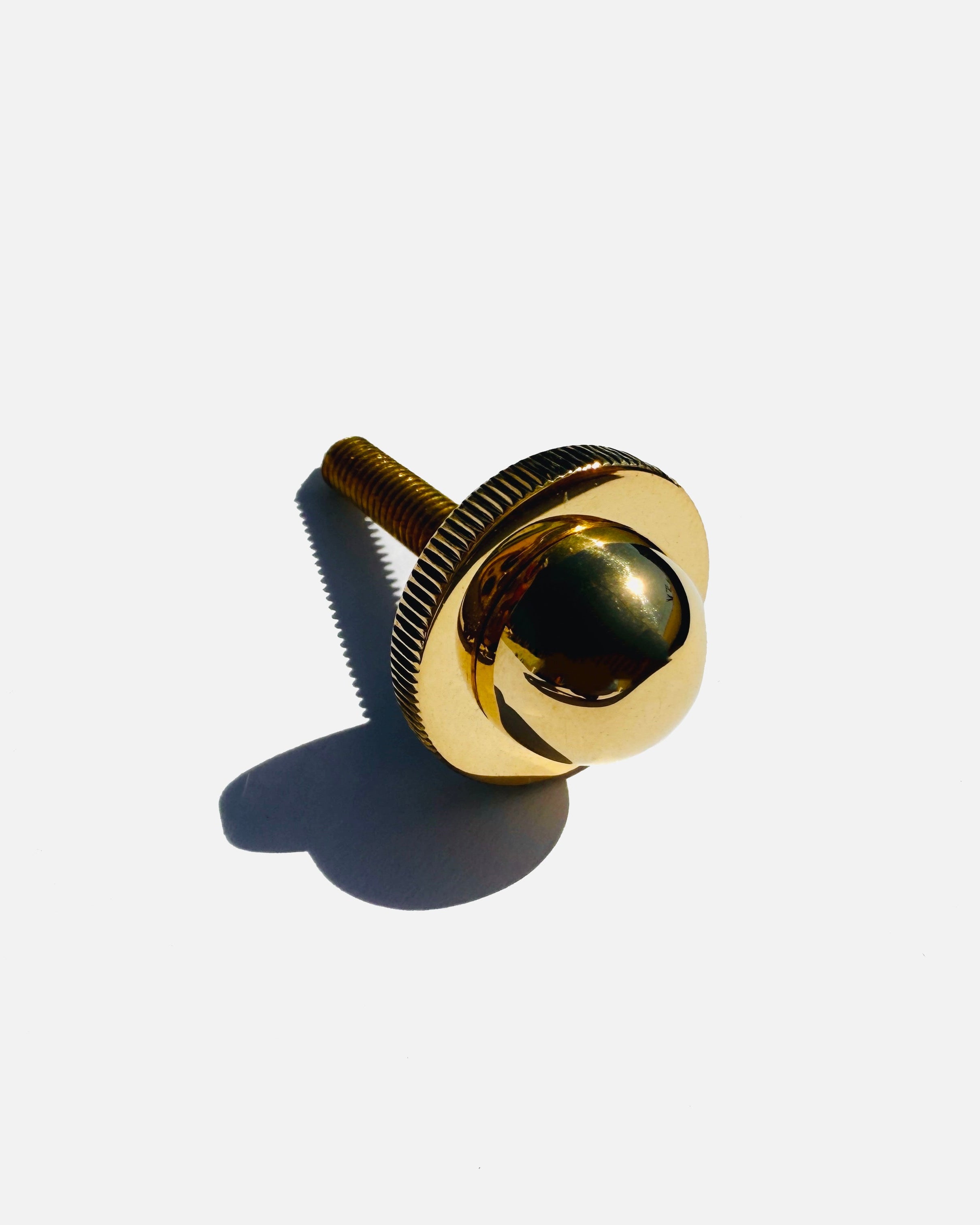Gold brass cabinet knob with dark green stone detail view