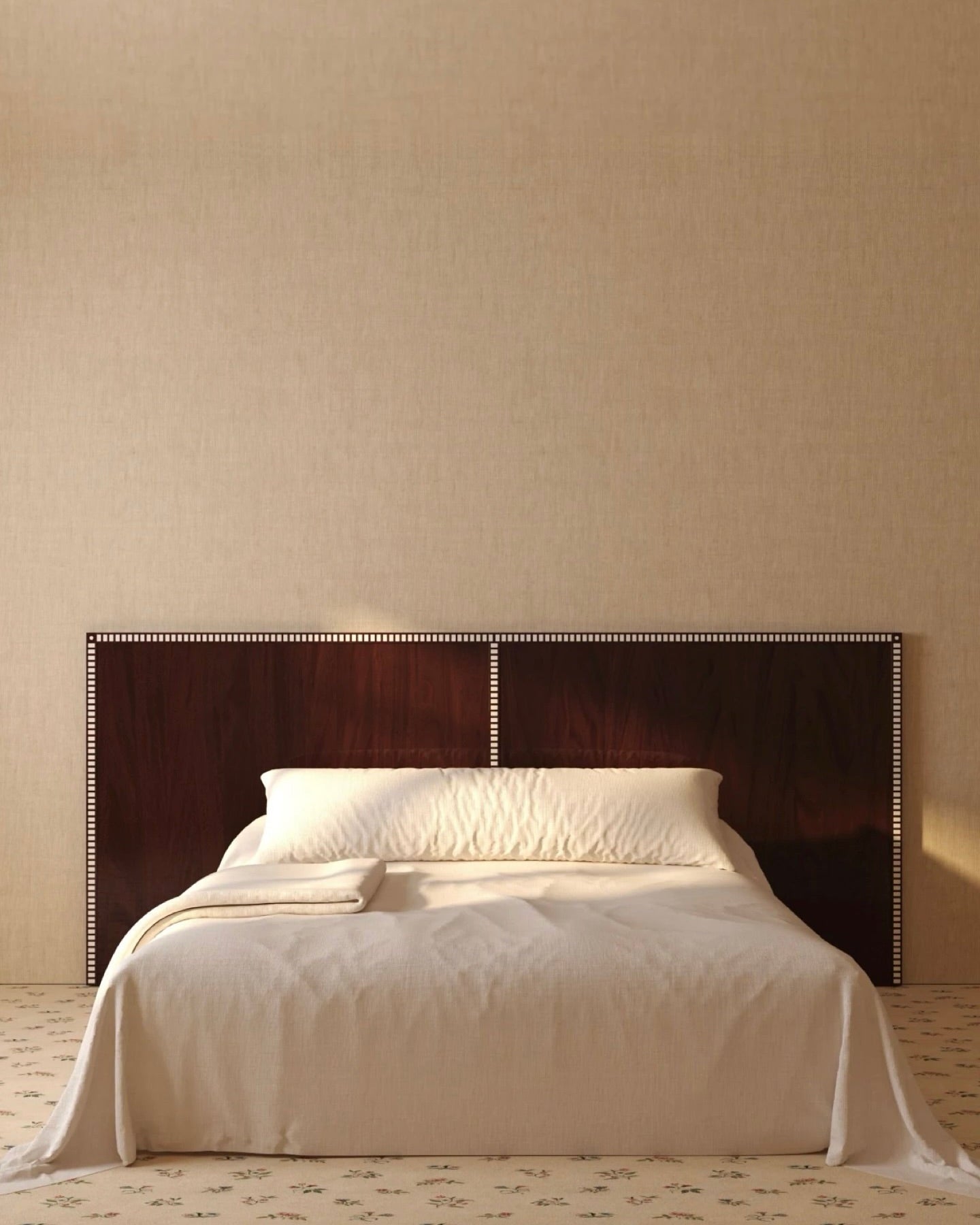 Aquarama mahogany headboard with brass nailhead trim on beige wall