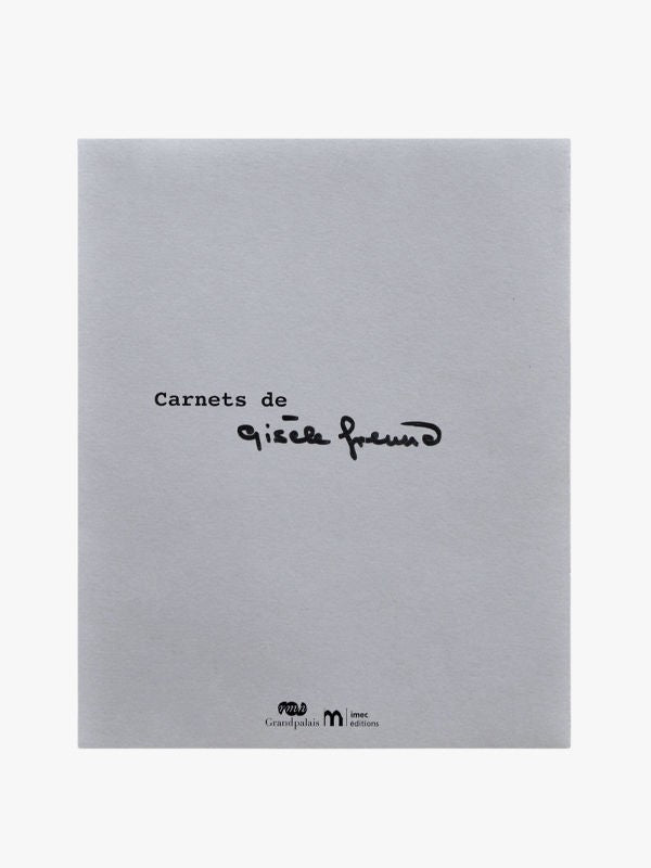 The gray book cover of "Carnets de Gisèle Freund" by Maison Plage showcases black handwriting, offering a minimalist aesthetic. Logos for "Grand palais" and "Imprimerie nationale éditions" at the bottom enhance its refined look.