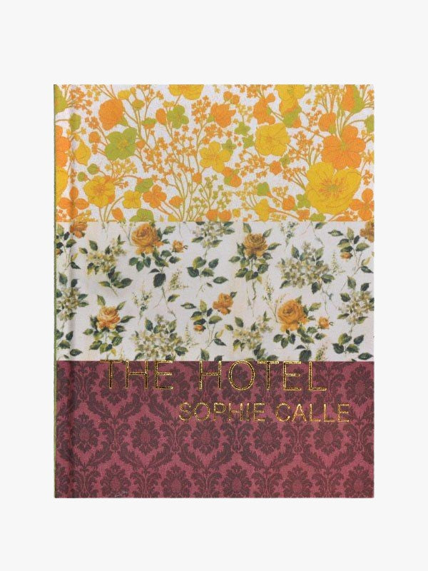 A book cover with a floral pattern in three sections: top in yellow, middle with green backdrop, and bottom in red, titled "Maison Plage Venice by Sophie Calle: The Hotel.
