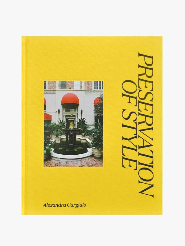A yellow book cover titled "Preservation of Style" by Maison Plage, featuring a photo of an elegant courtyard with a fountain and palm trees, flanked by buildings with arched red.