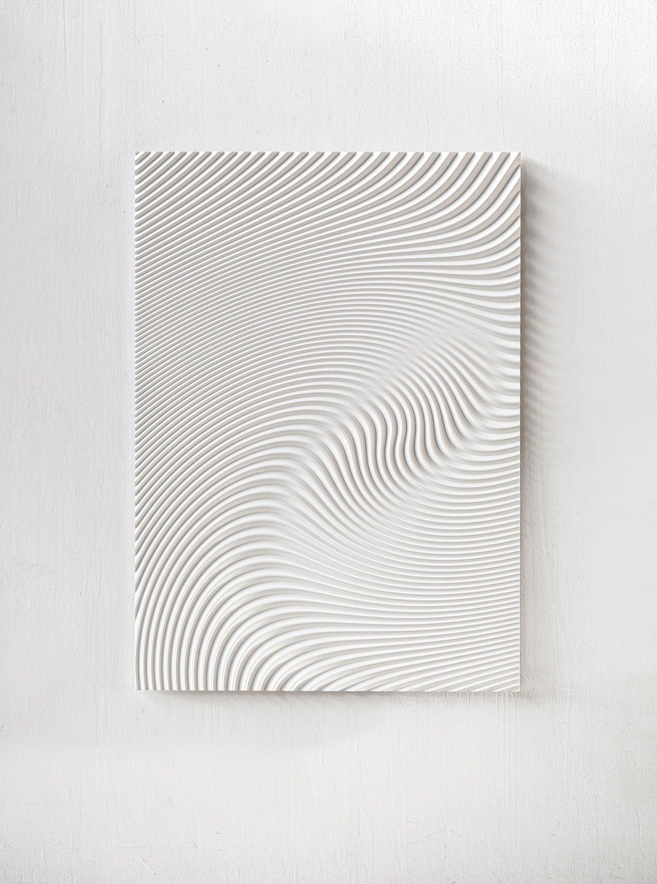 The Wave White panel by Studio Arno Hoogland features wavy, raised ridges that form an abstract, flowing pattern with smooth curves and a sense of movement on a plain white background.