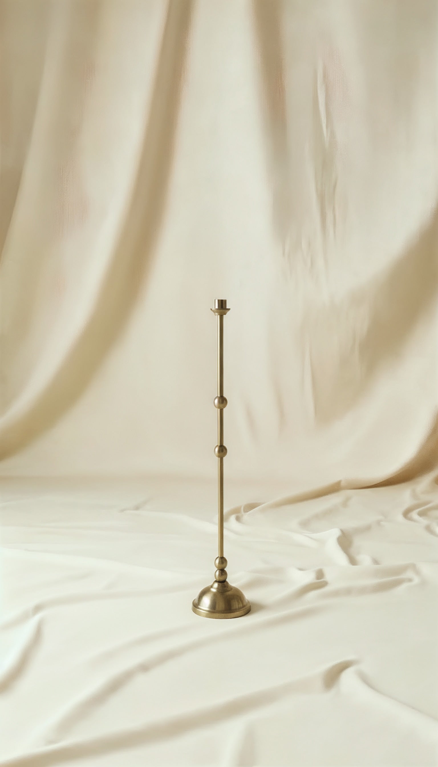 ASHA I – Brushed Brass Sculptural Candlestick Set — back view on soft fabric backdrop