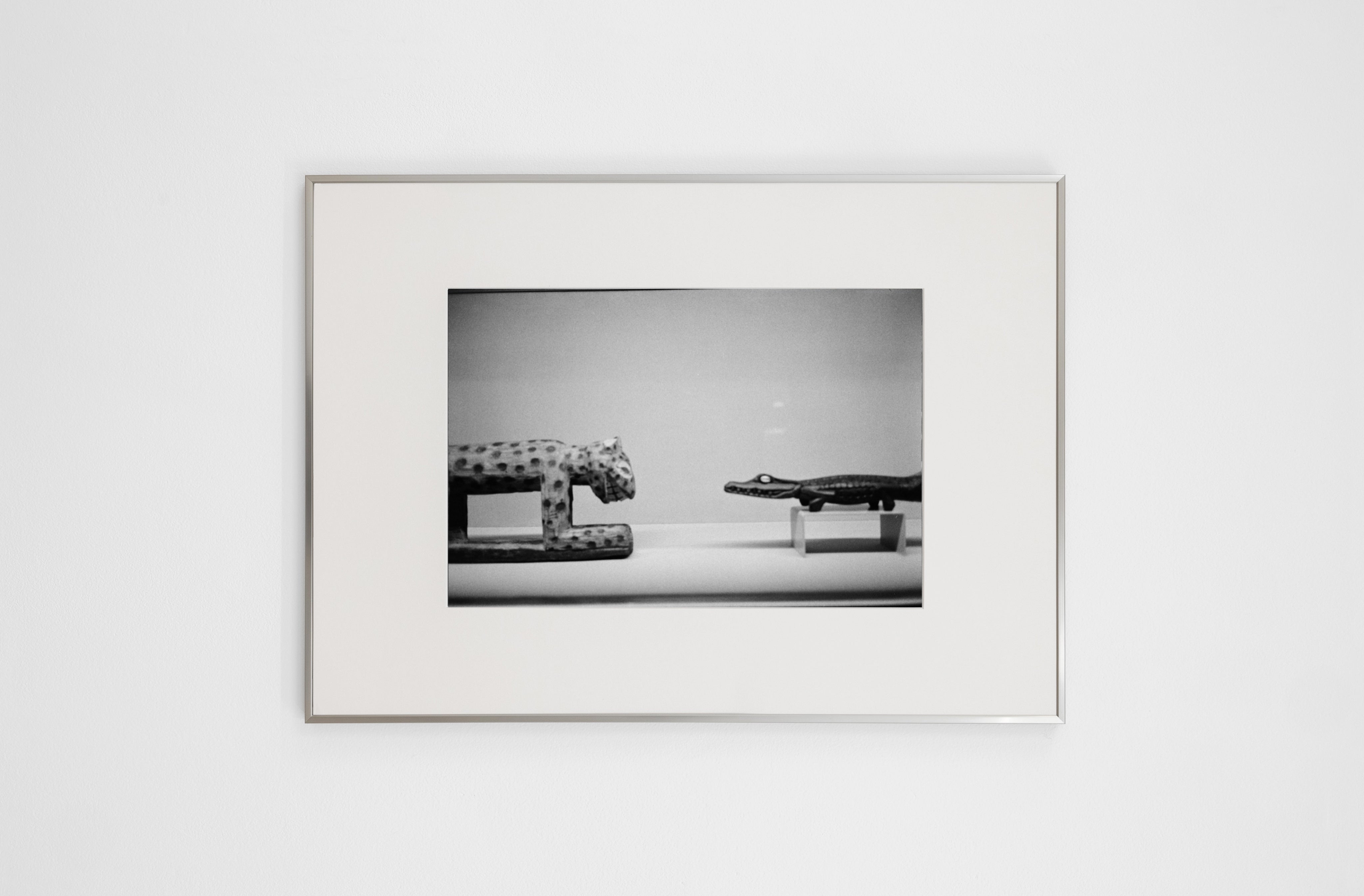 Memory #07 by COSEINCORSO is a limited edition contemporary photography print in an aluminium frame, featuring two animal figurines—a spotted cat and an alligator—face-to-face on a plain background in striking black-and-white.