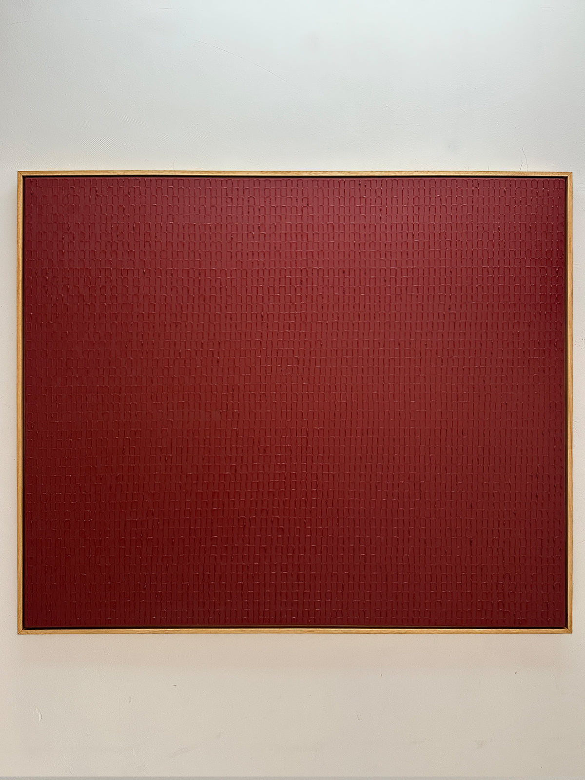 Abstract red textured painting with geometric pattern by Roi Elmaliah