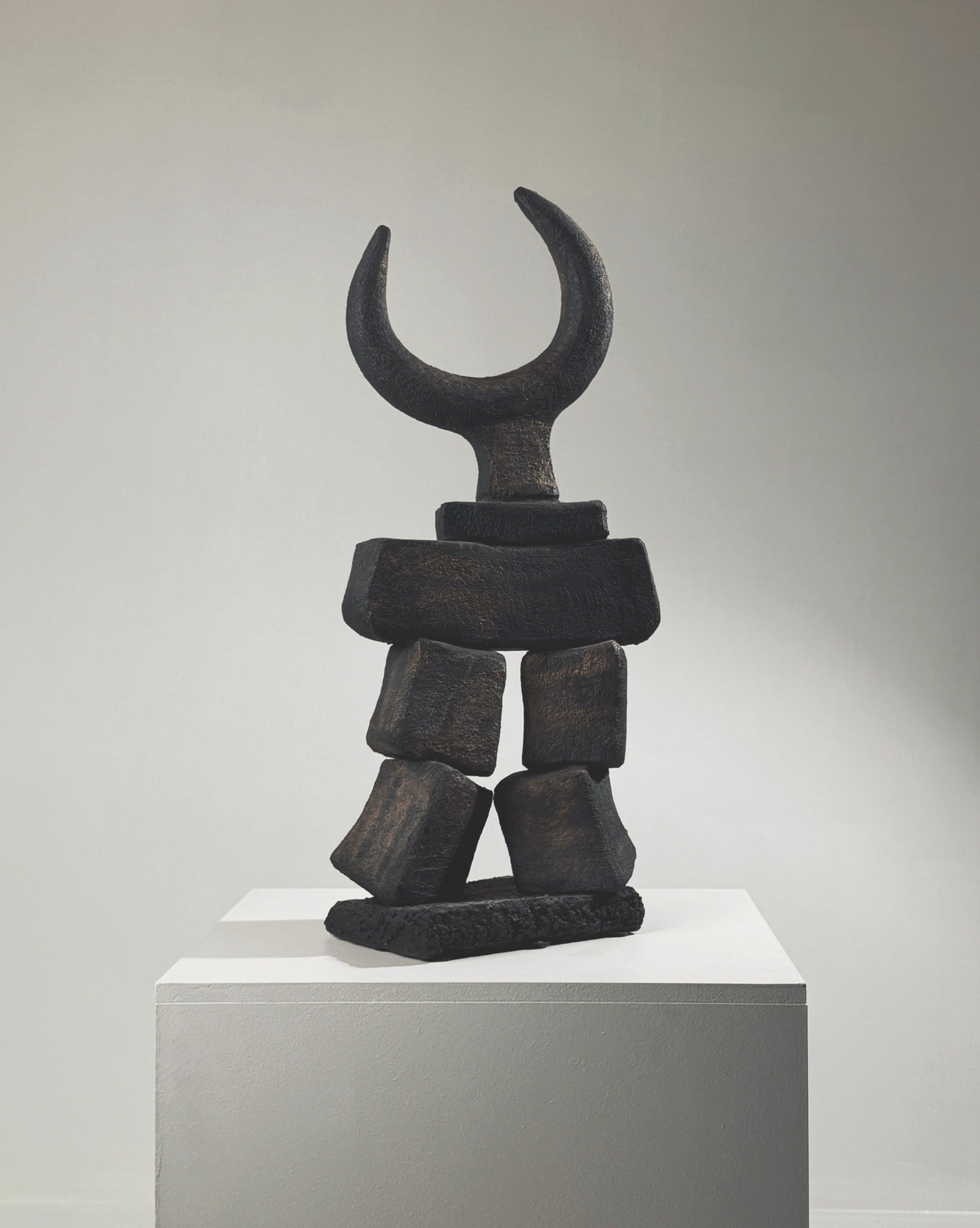 Black stone Toro totem sculpture by Dominique Pouchain with crescent moon