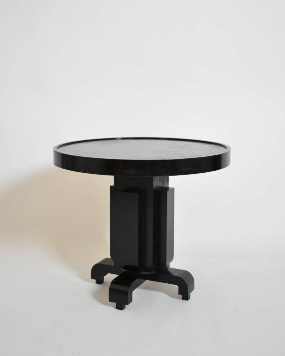 The Barracuda Interiors Round Ebonised Art Deco Geometric Side Table (1930s) features a thick top and central pedestal base with four curved legs, shown against a plain white background.