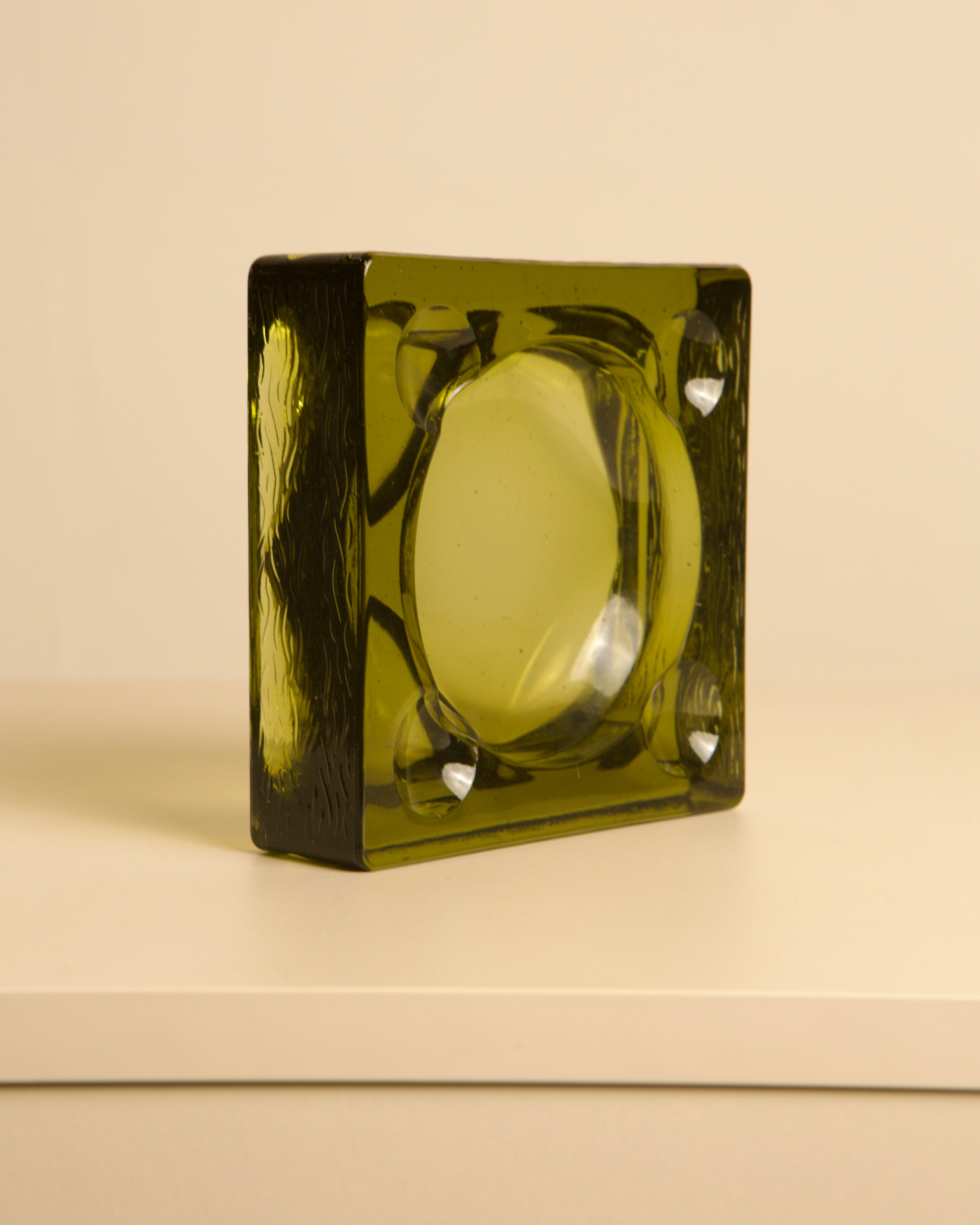Italian dark green glass ashtray with geometric bowl design, 1970s
