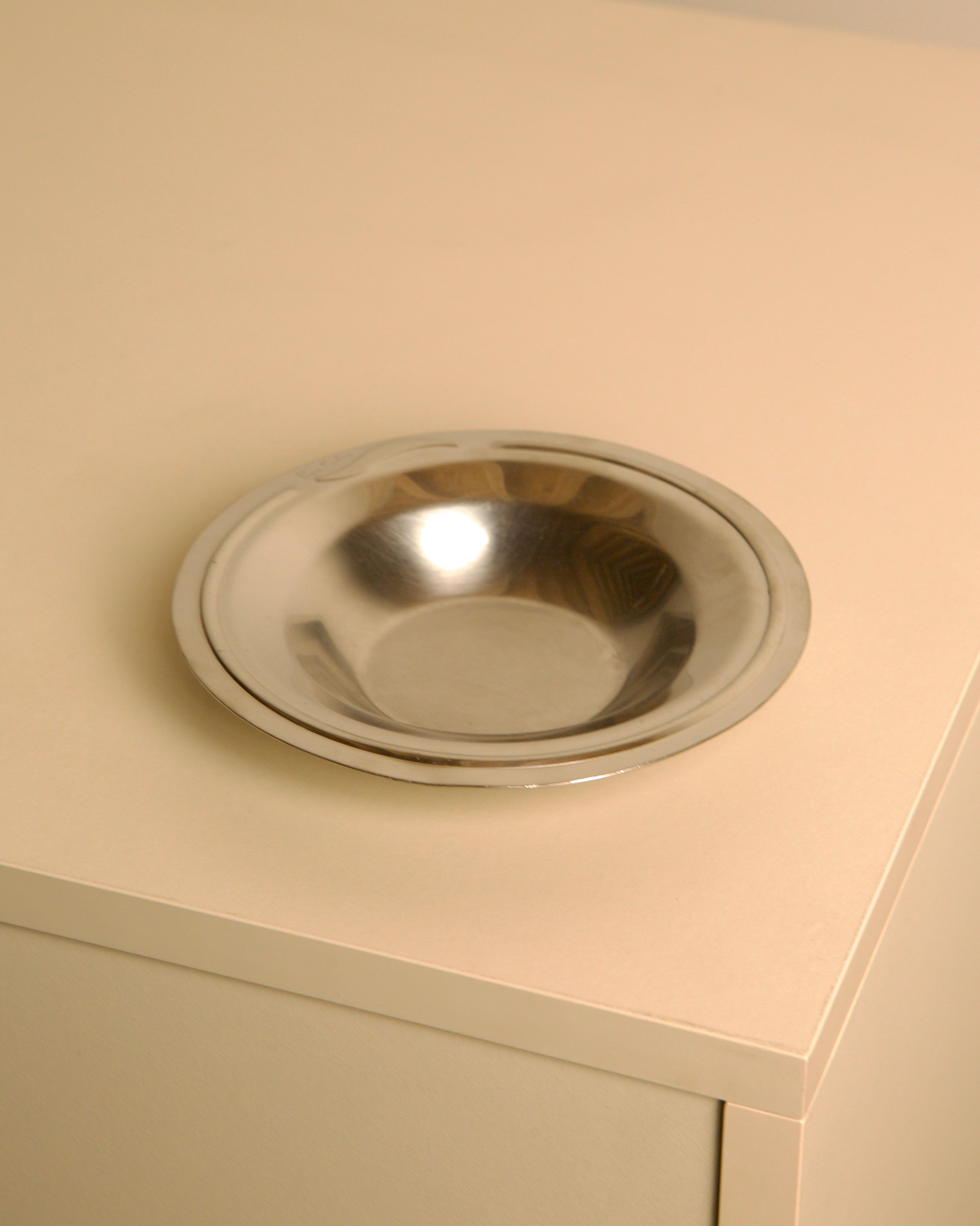 Circular stainless steel valet tray by Pierre Cardin, 1980s | The Oblist — vintage modern design