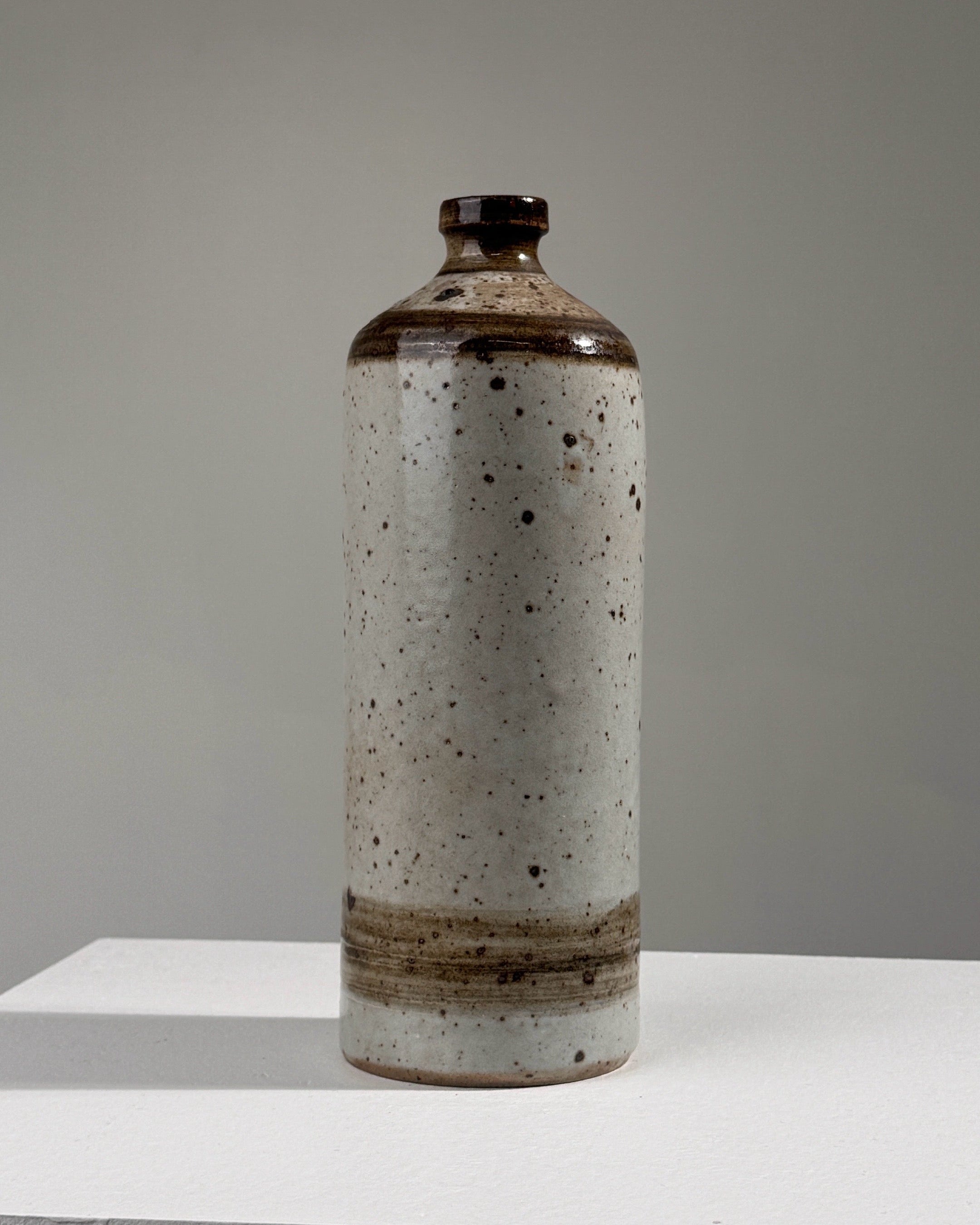Pyrited stoneware bottle vase with speckled white glaze finish