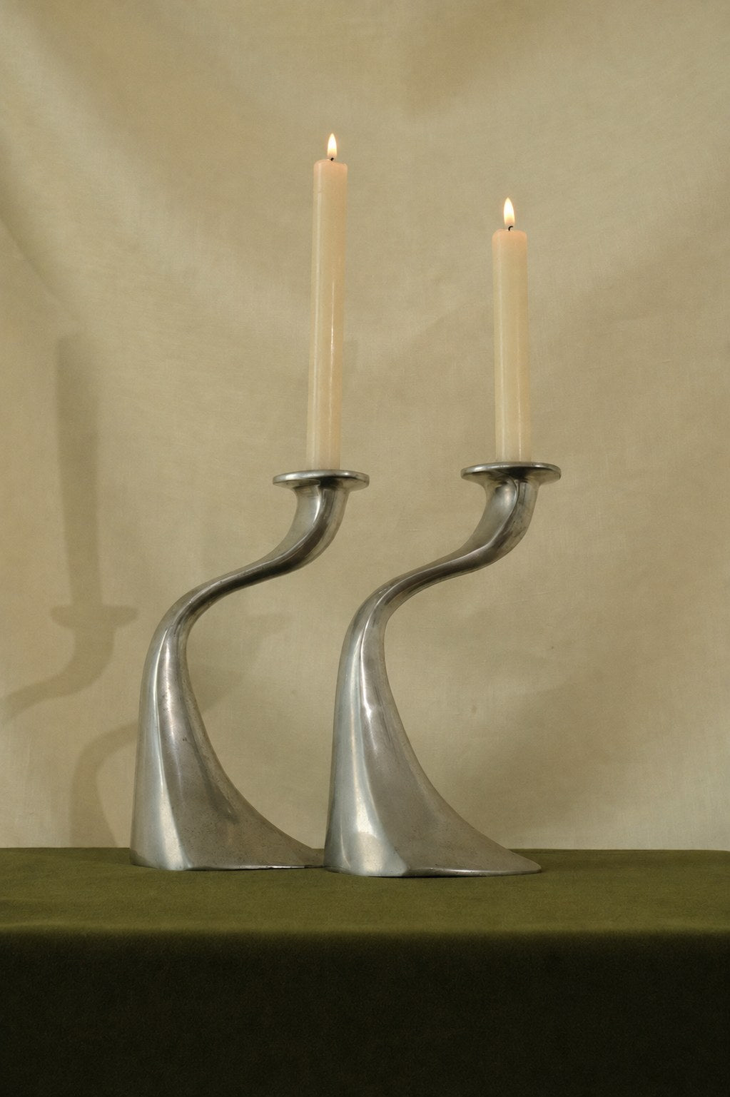 A Sculptural Set of 2 Inox Candle Holders — side angle