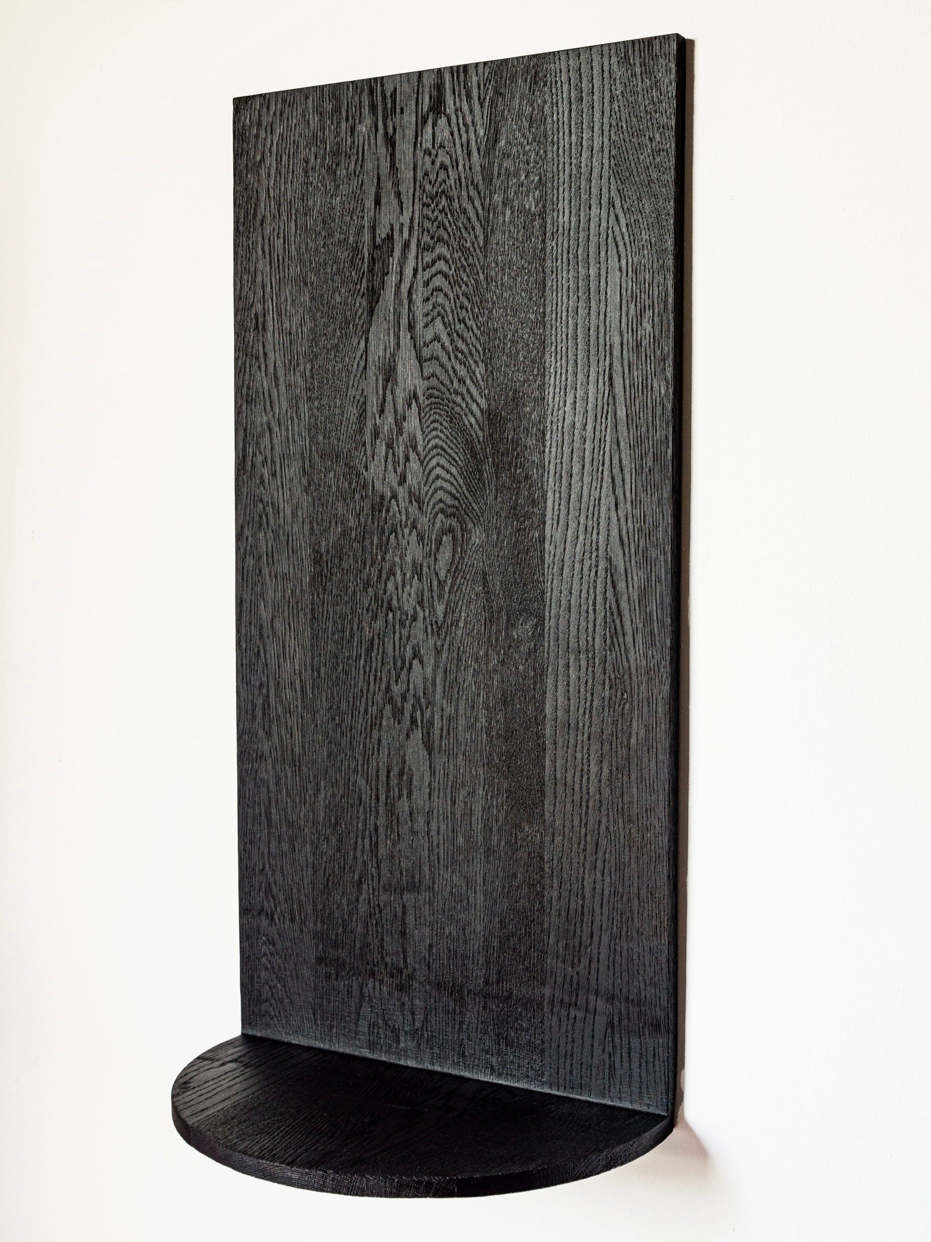 Black oak Megaron wall shelf with curved base from COSEINCORSO