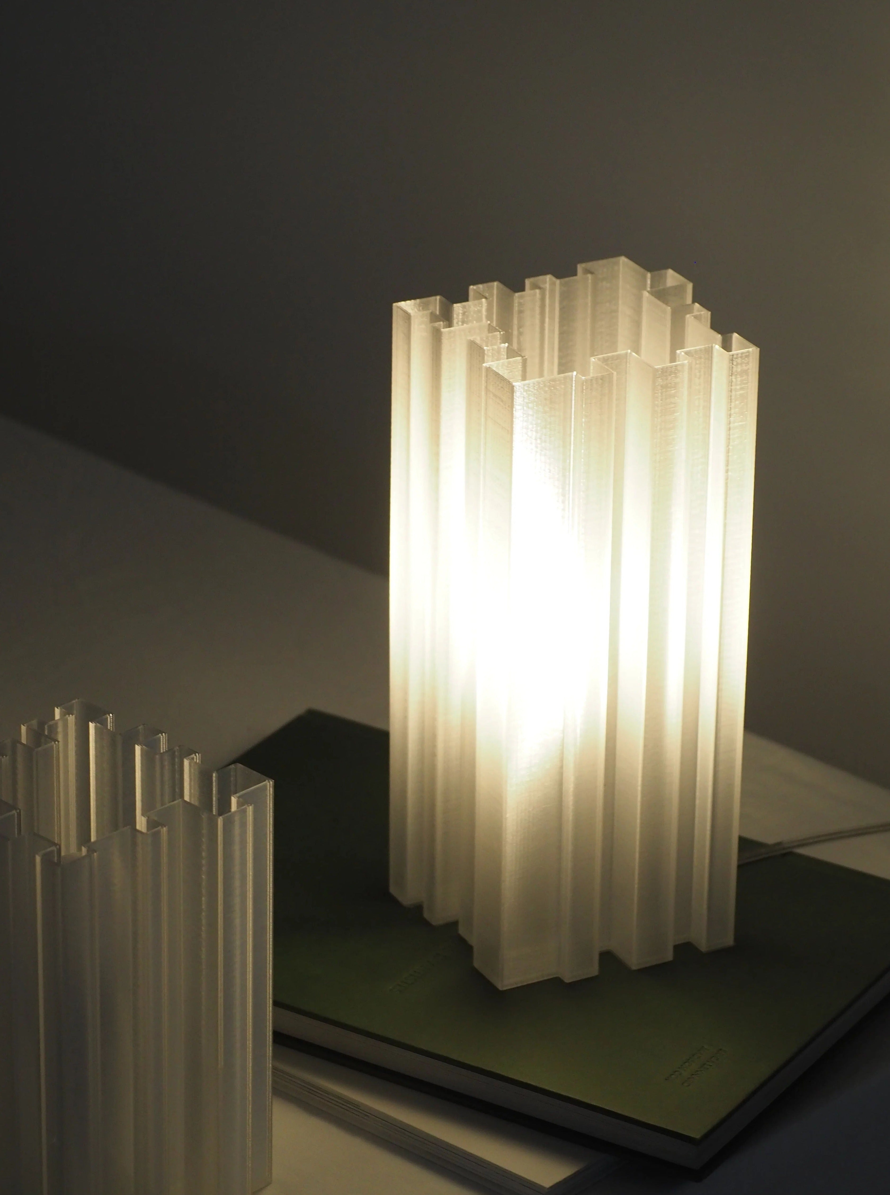 Orgue Lamp with silver base and white shade illuminating a modern living room