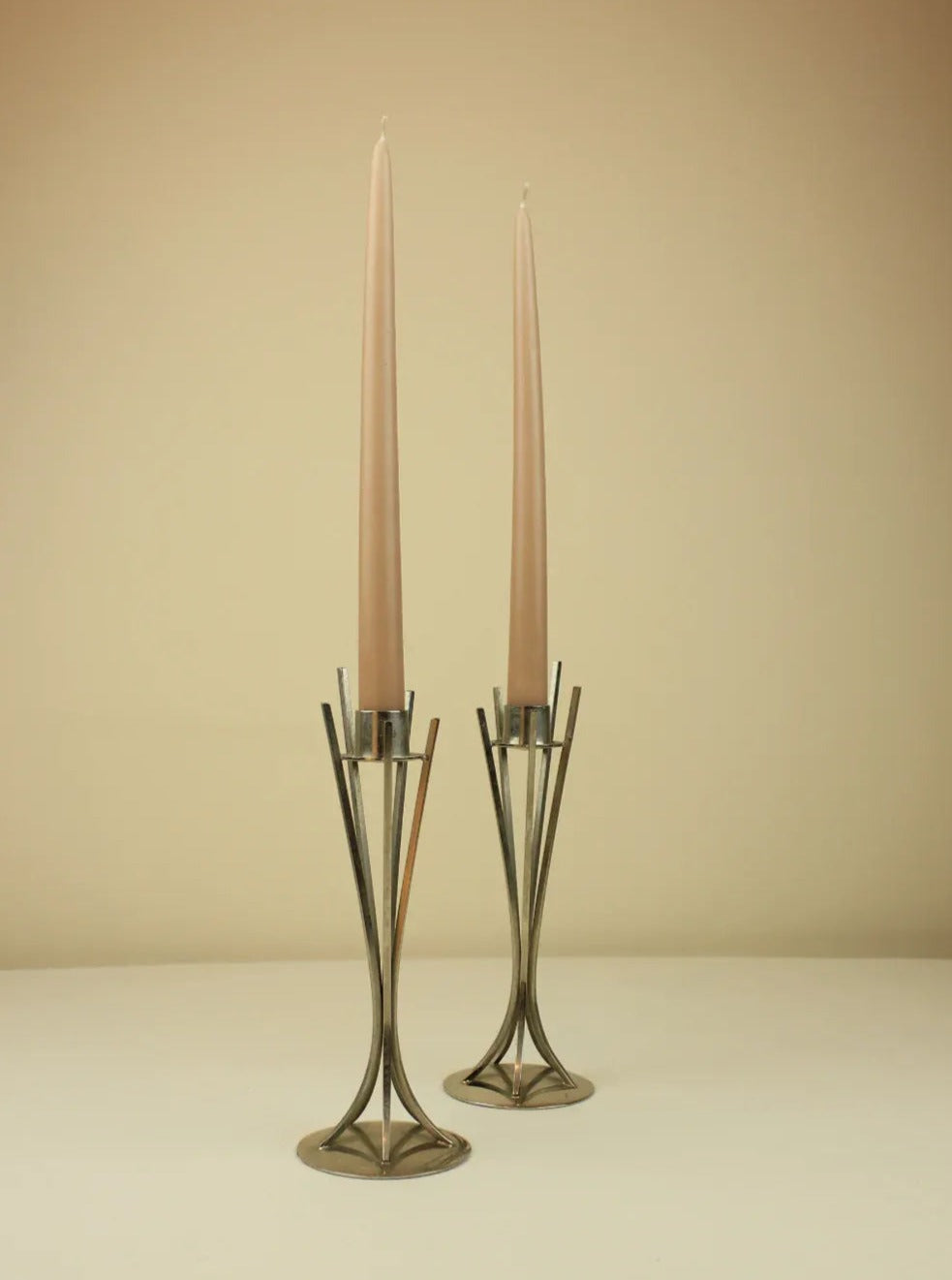 Set of two brass mid-century modern candleholders with geometric design