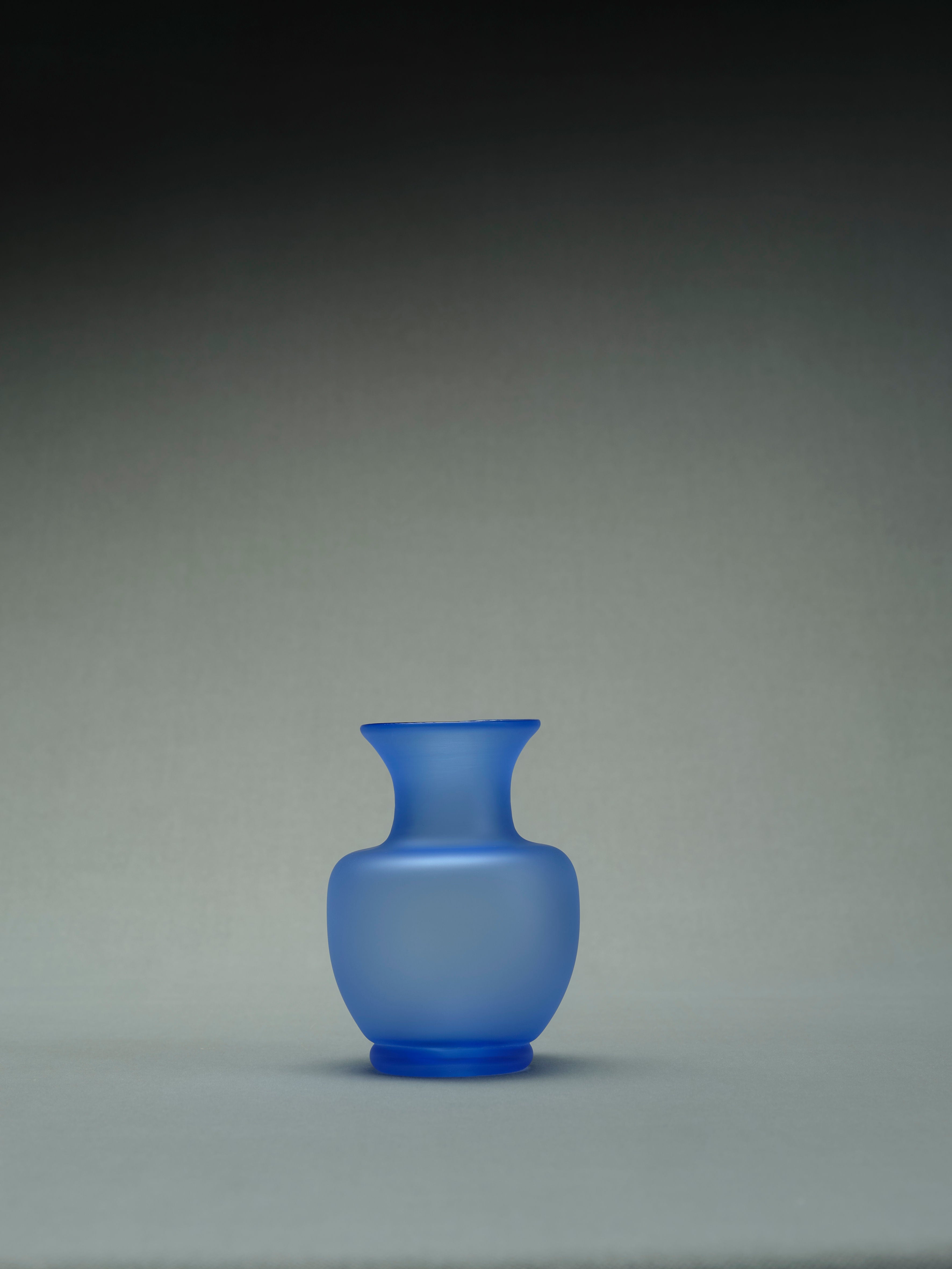 Small blue ceramic vase with intricate hand-painted floral design