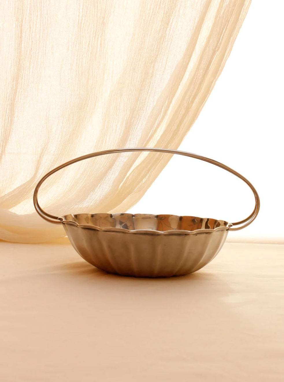 Beautiful silver-plated fruit bowl with intricate designs and a polished finish