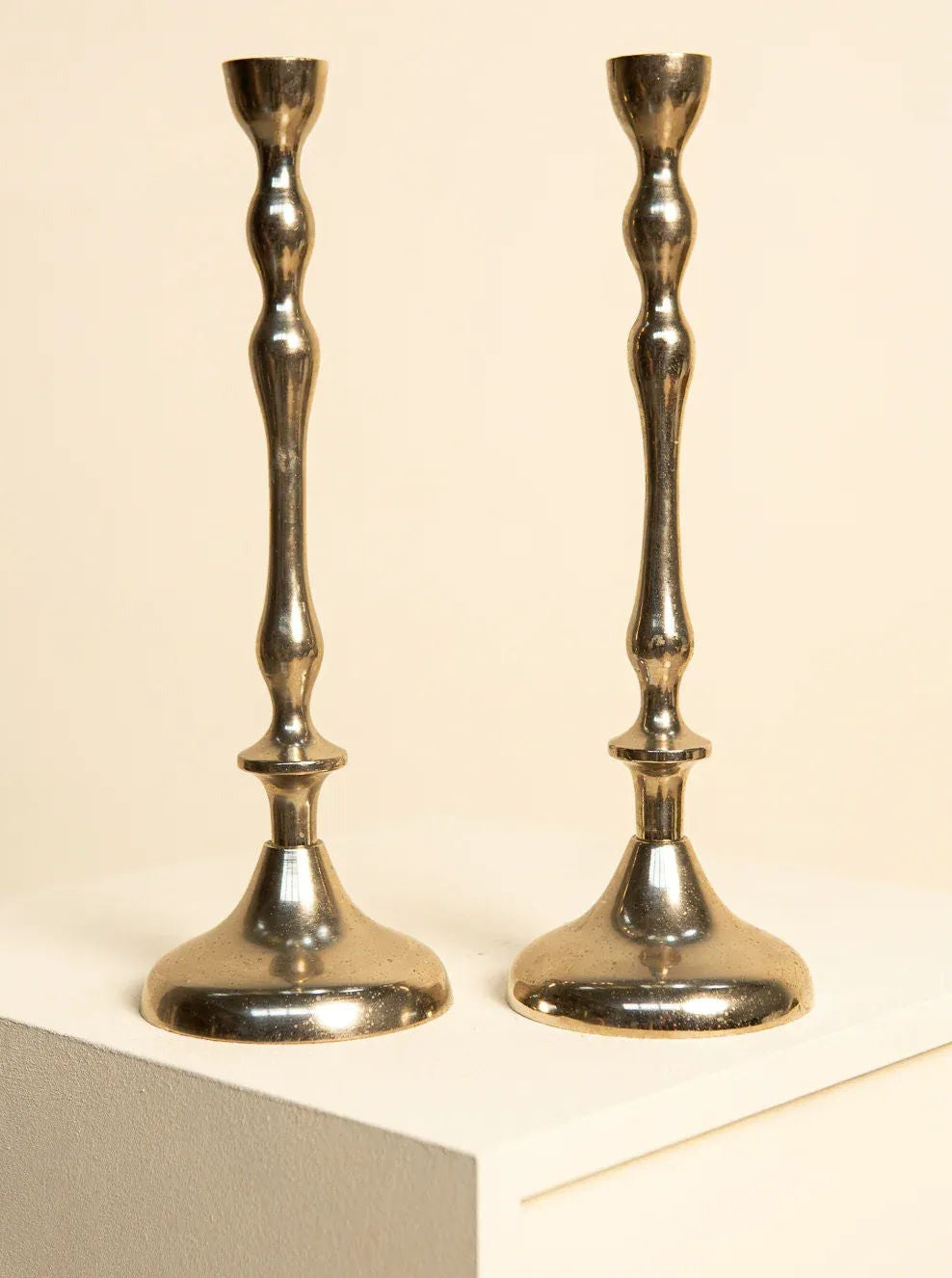 Pair of tall 80's Italian candleholders in gold and silver tones