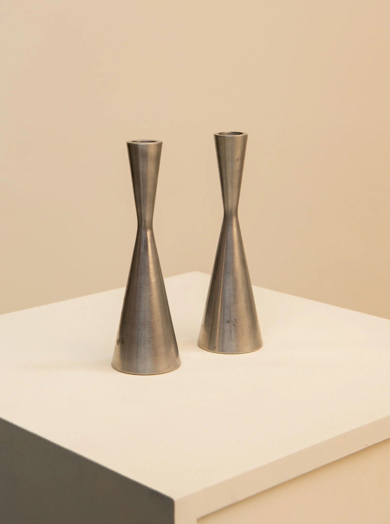 Two Pair of Candlesticks by Erika Pekkari for Ikea 90's in a conical shape, displayed on a white surface against a soft beige background, exemplify 1990s home decor.
