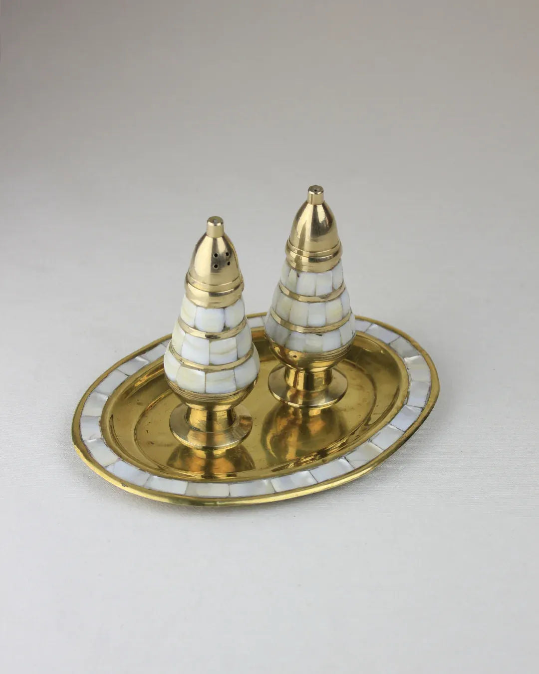 Mother of Pearl Salt and Pepper shakers on a marble countertop