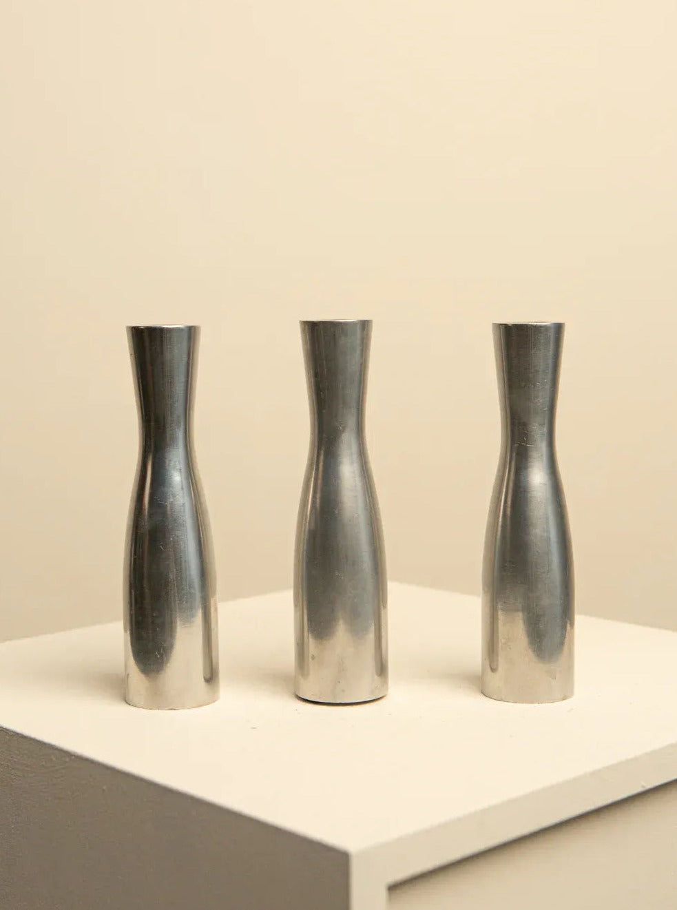 Shiny and elegant set of vintage candleholders, made of chrome-plated metal, designed by Erika Pekkari in the 1990s