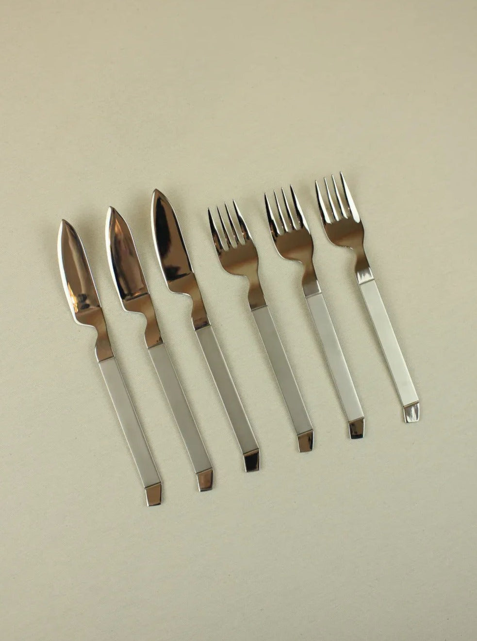 Modernist fish cutlery made of sleek stainless steel with ergonomic handle design